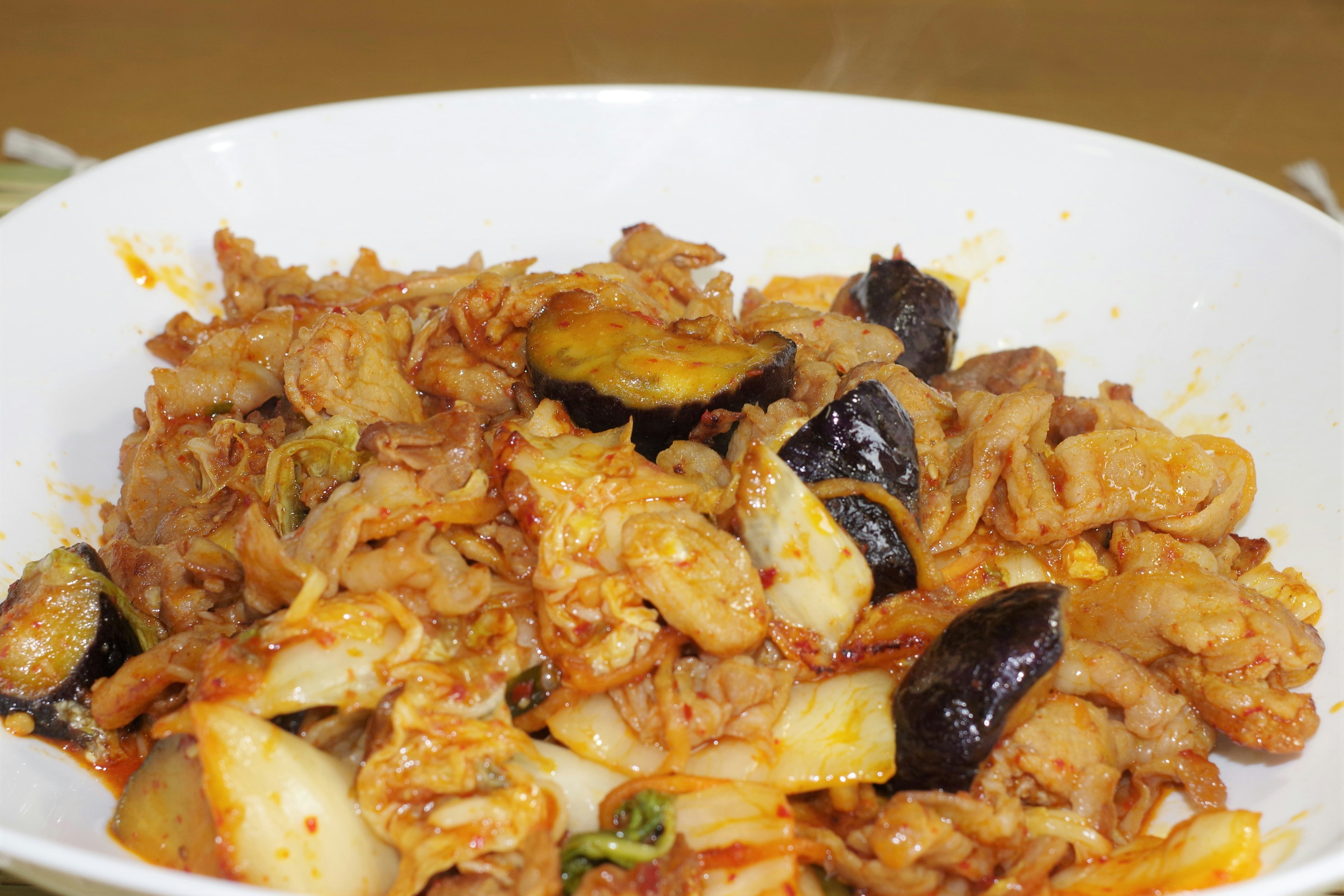 Dish of stir-fried vegetables and chicken served in a white bowl