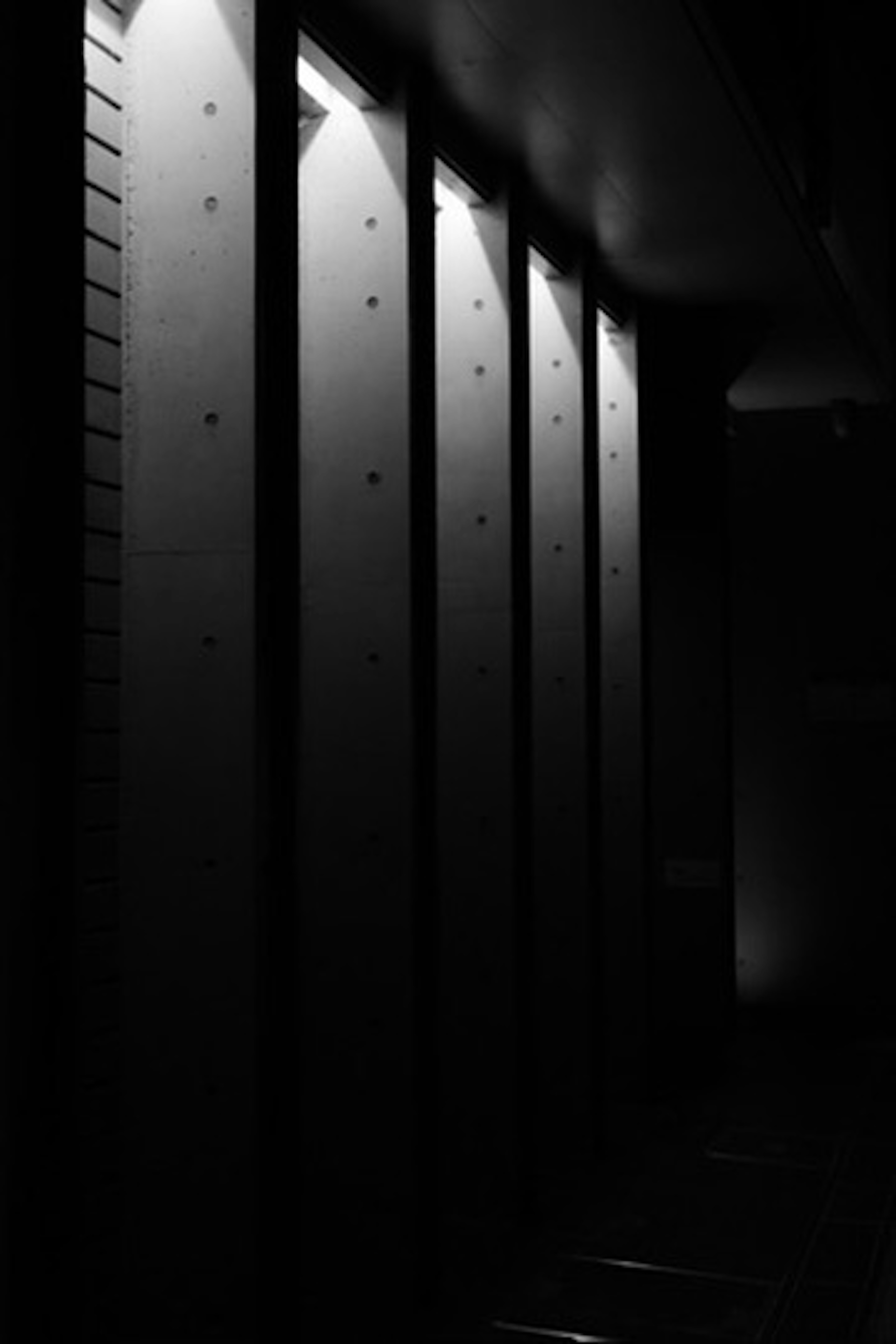 Concrete walls illuminated against a dark background