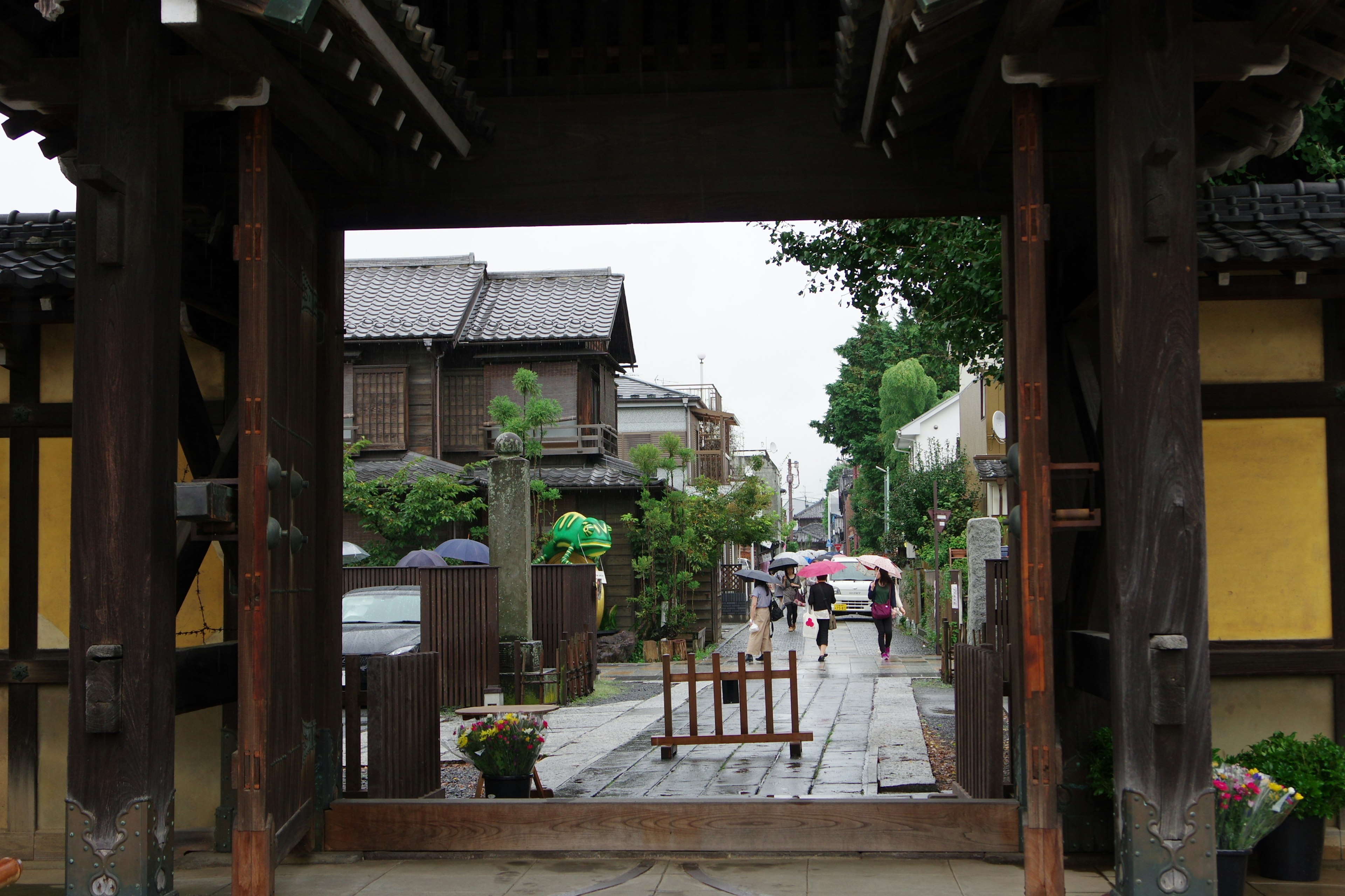 Bogen, der zu einer traditionellen japanischen Straße mit gehenden Menschen führt