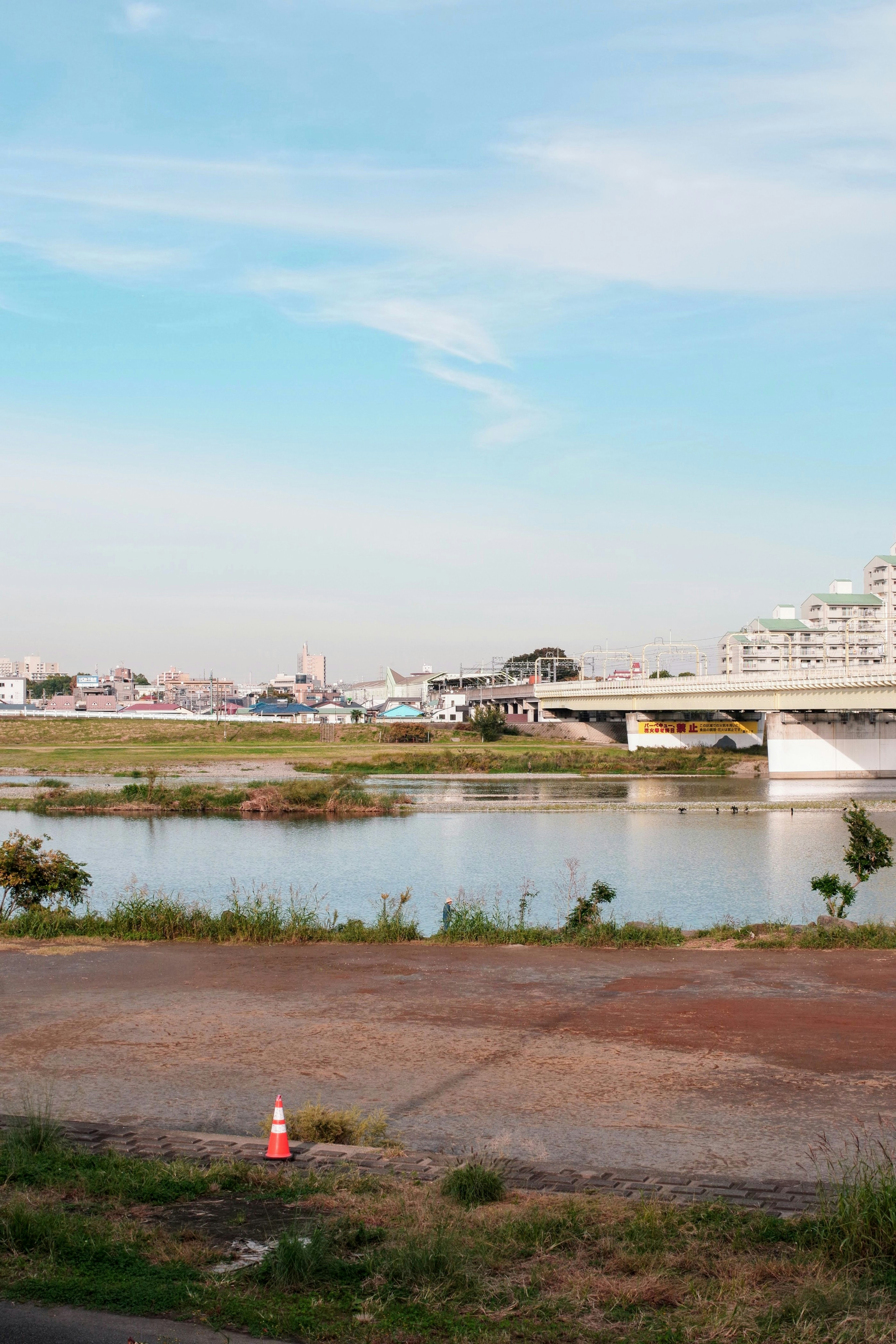 Vista escénica de un río con un puente bajo un cielo despejado y edificios al fondo