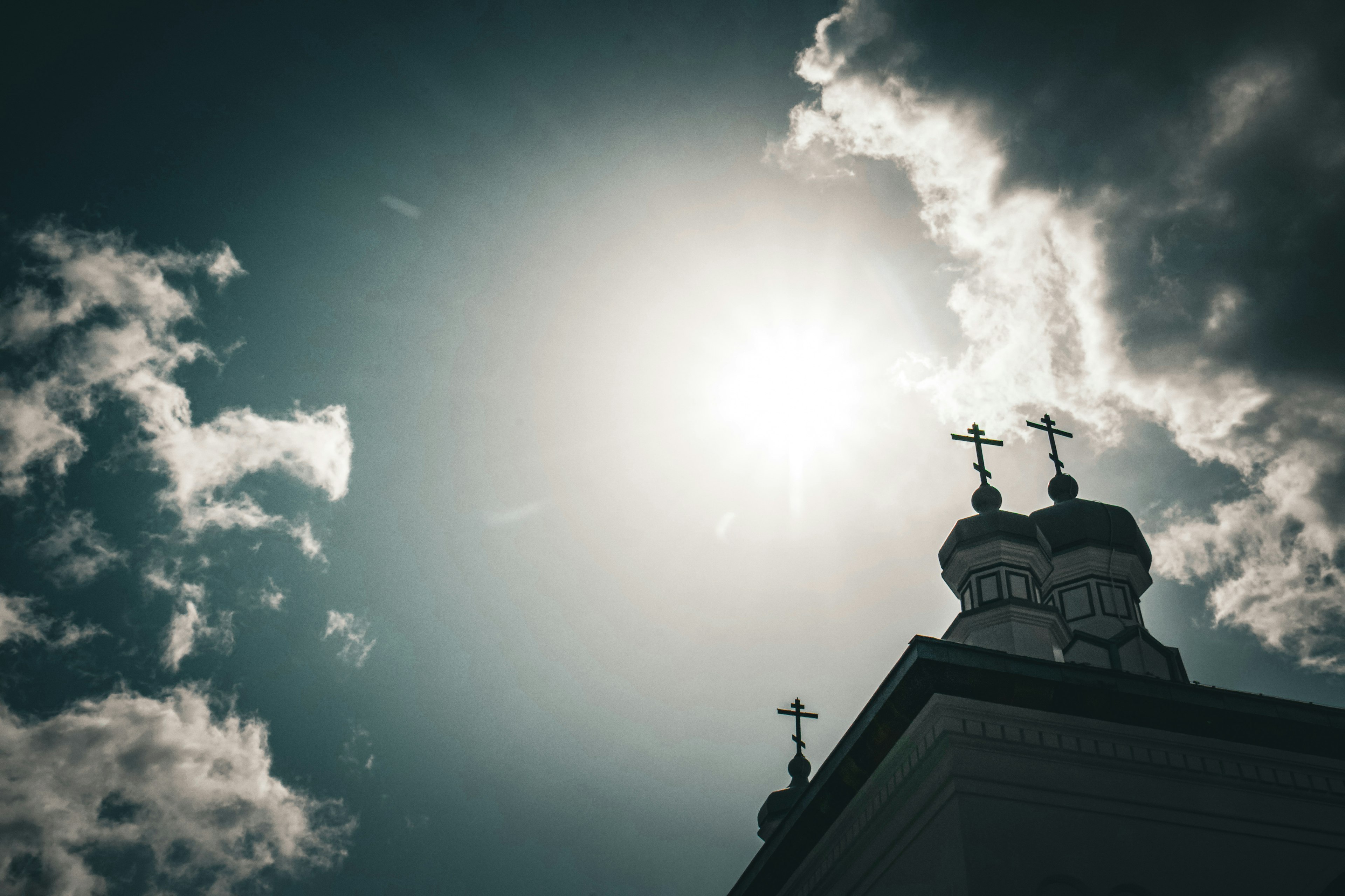 Church dome with crosses against a bright sky