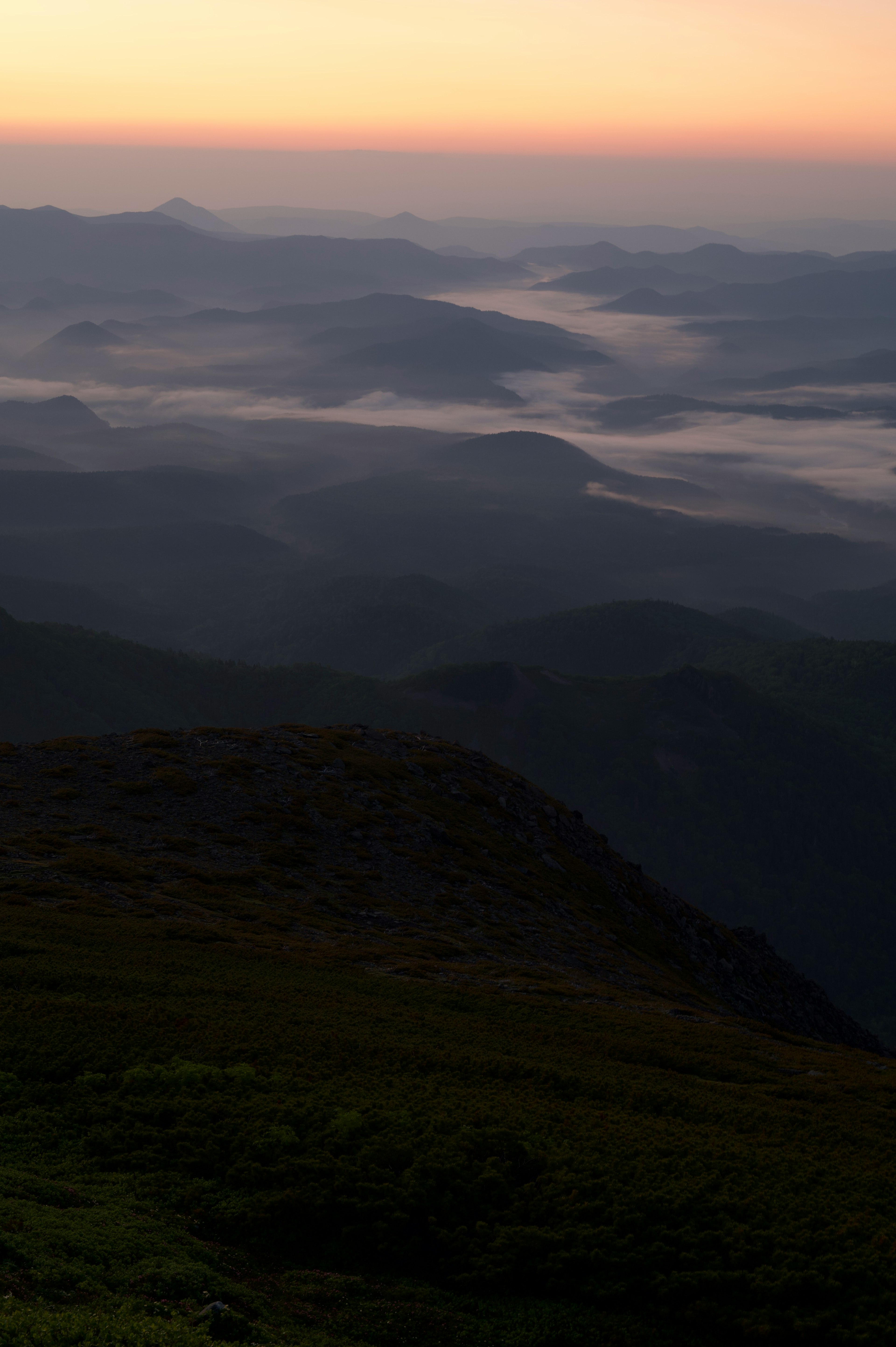 夕暮れ時の山々の風景 霧に包まれた谷間と流れる川の景色