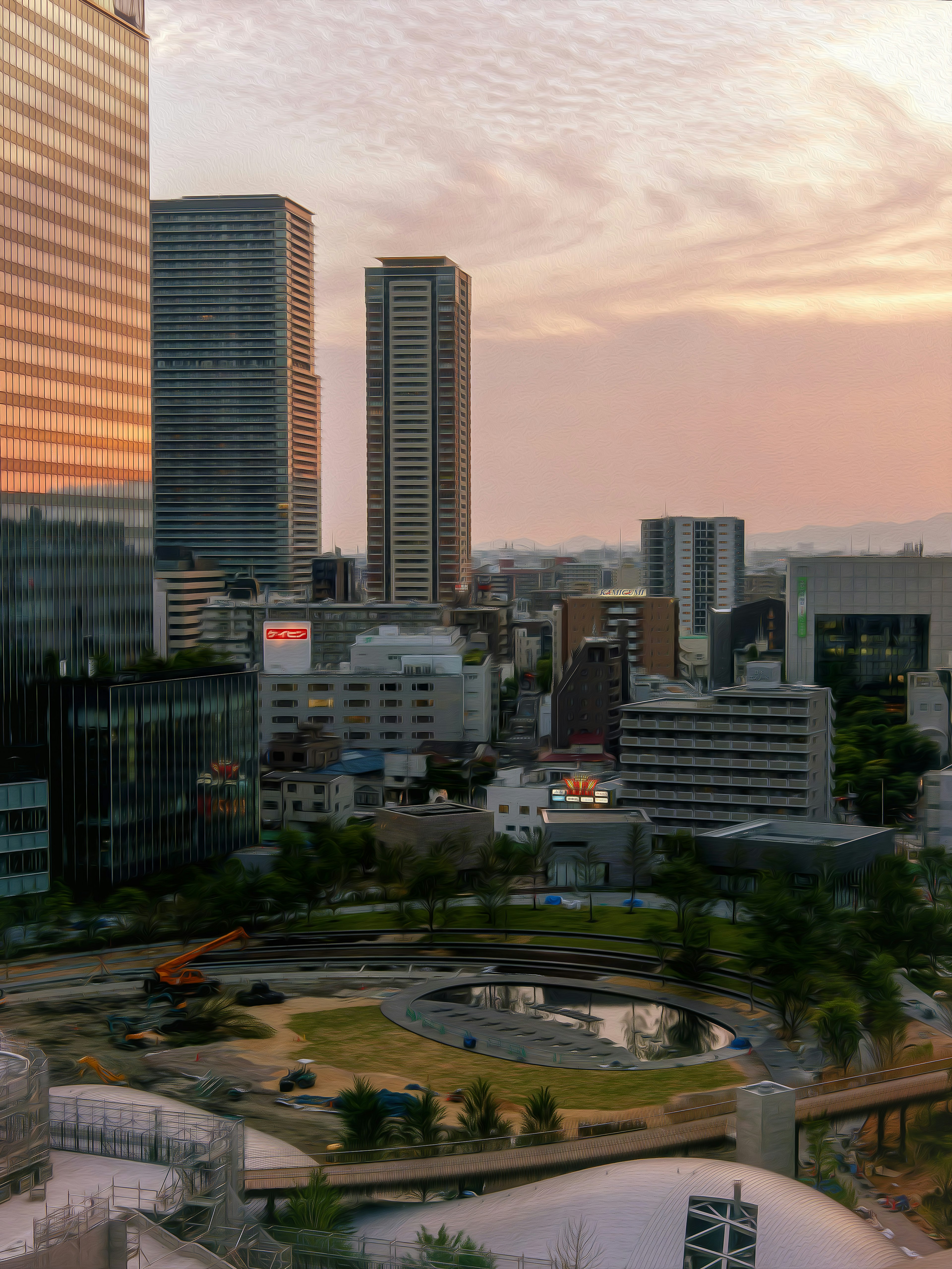 夕焼けの中の高層ビル群と公園の風景