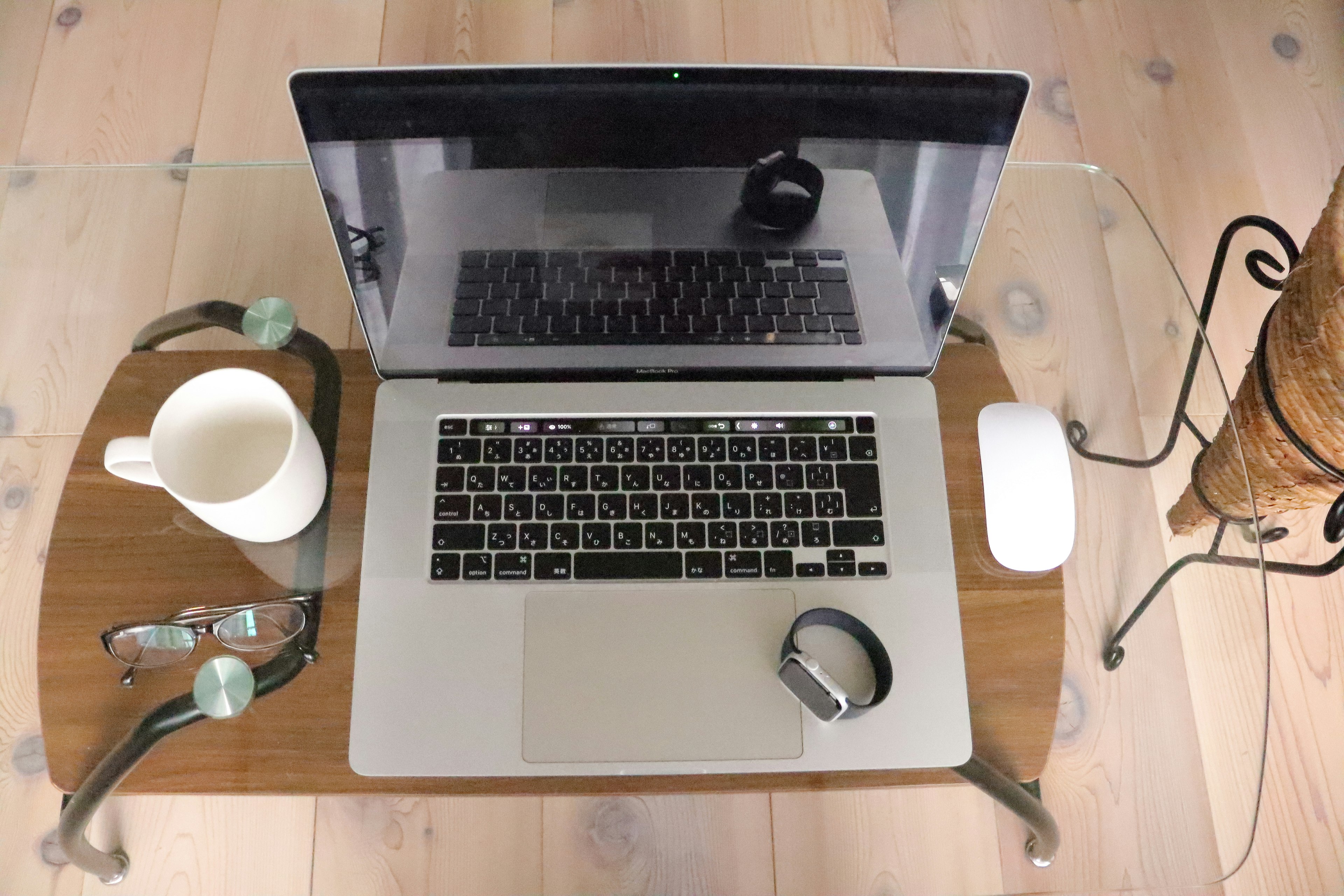 Laptop auf einem Holztisch mit einer Tasse Kaffee und einer Brille