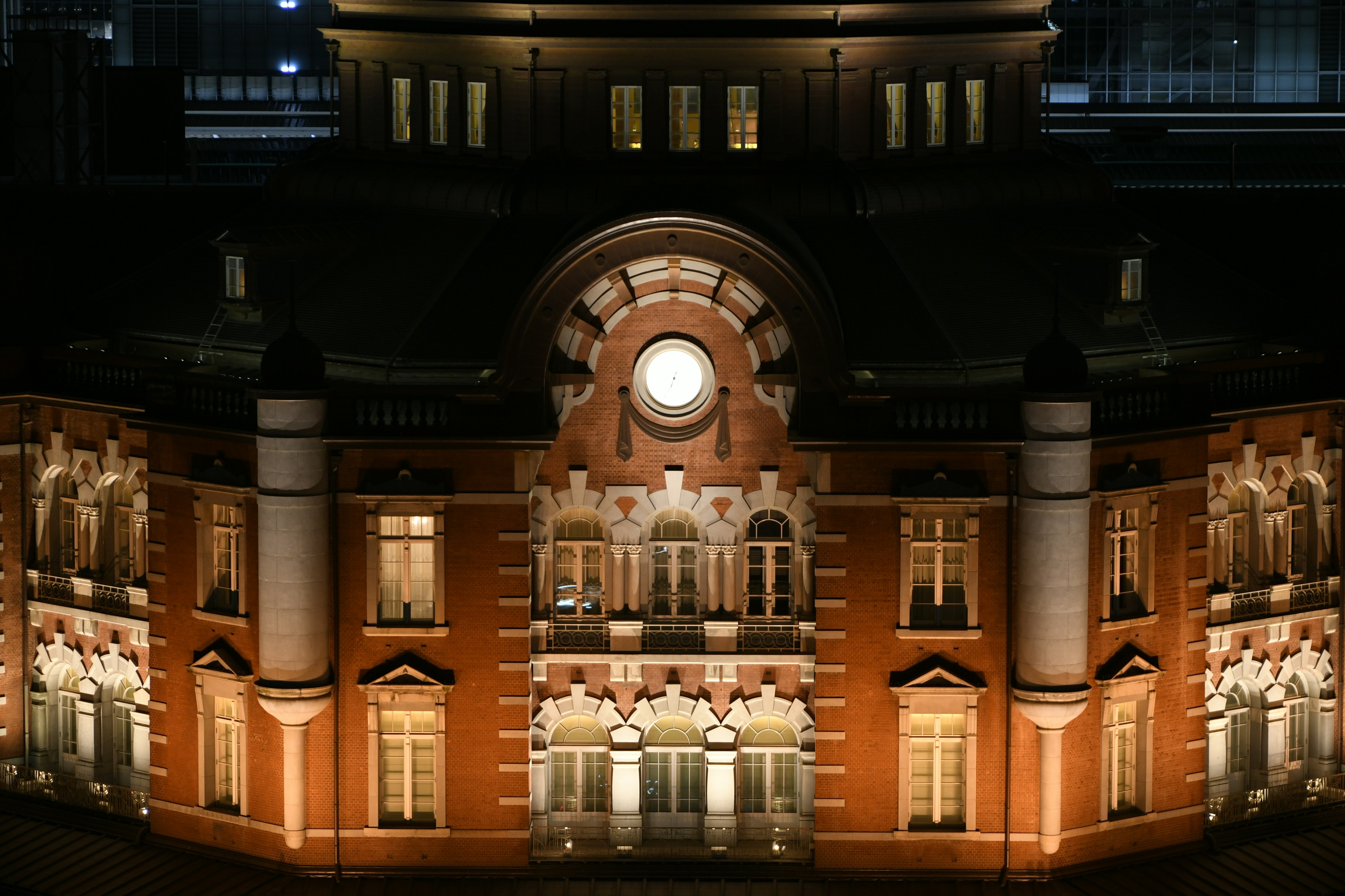 Tokyo Station at night featuring red brick and white columns