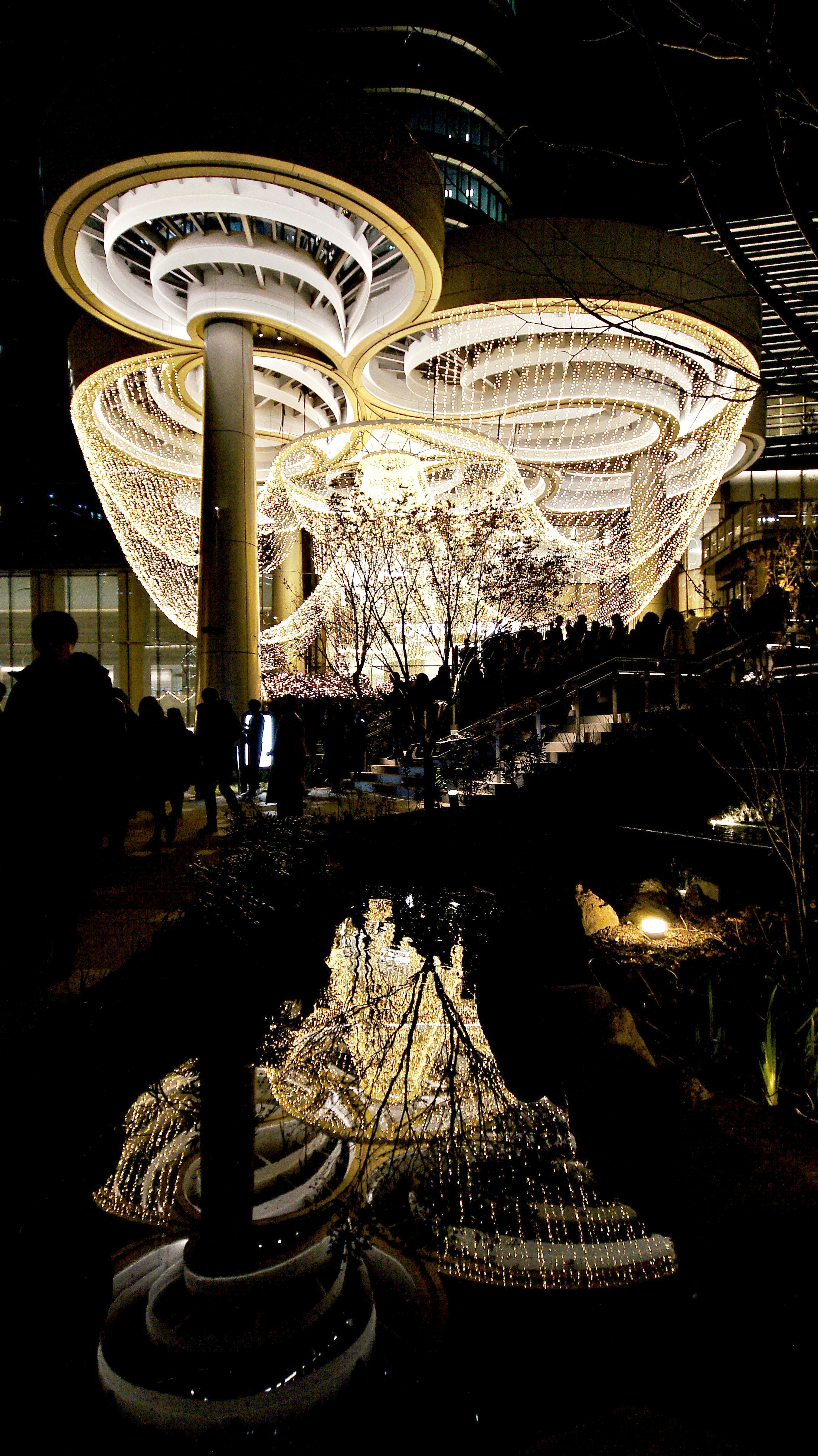 Beautifully lit outdoor art installation with reflections