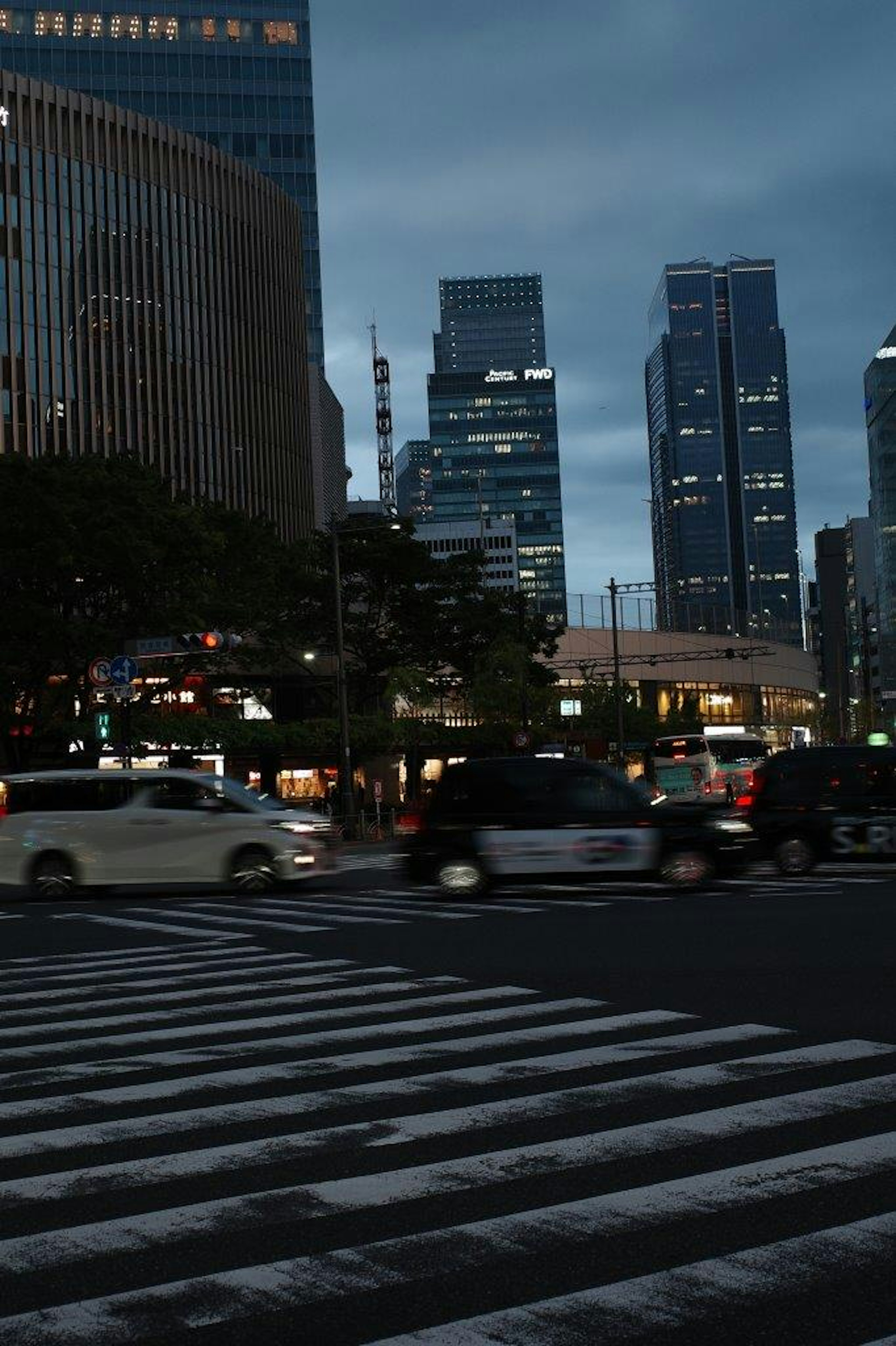 Night cityscape featuring a crosswalk and skyscrapers