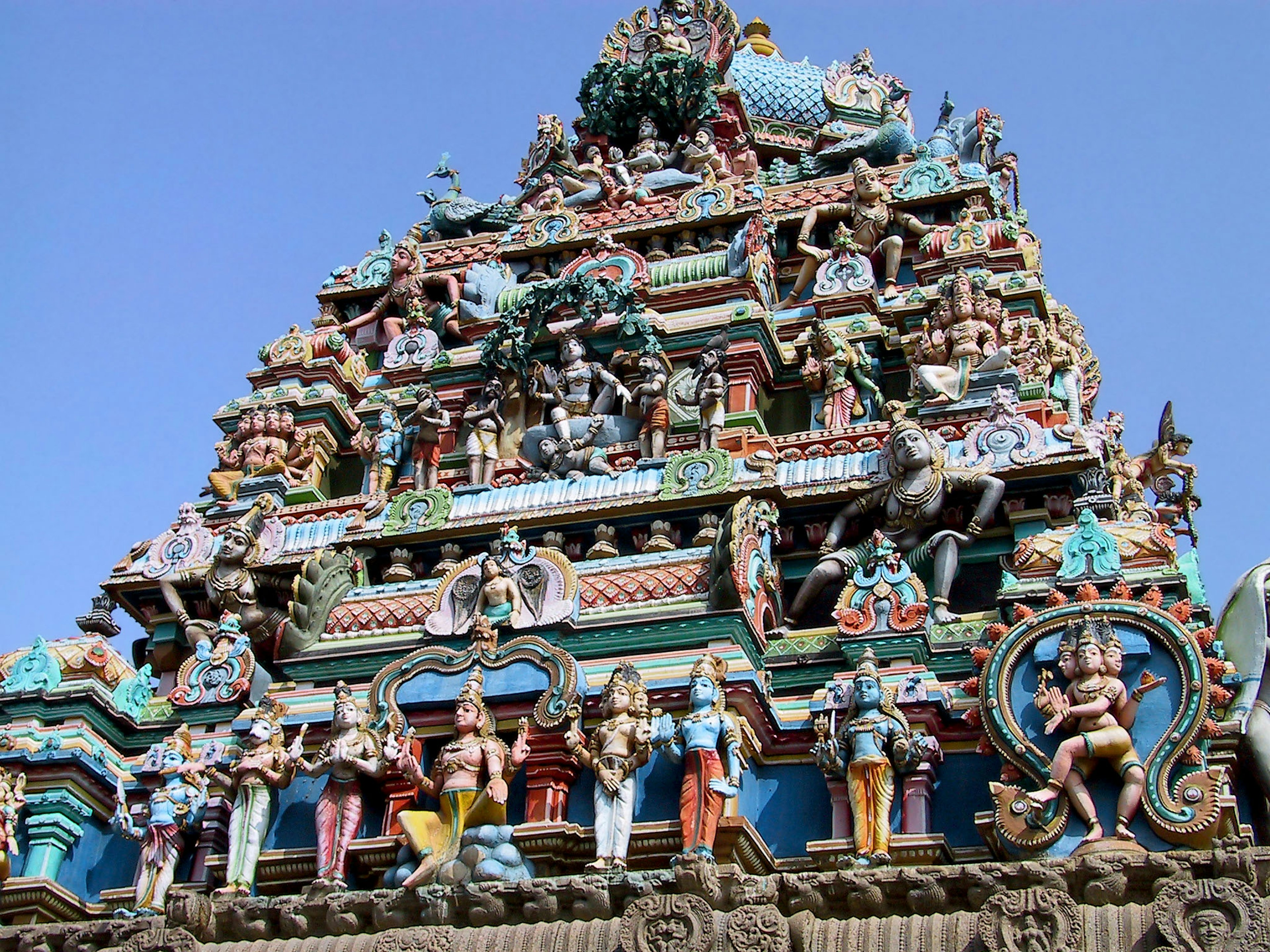 Detailed view of a temple tower adorned with colorful sculptures