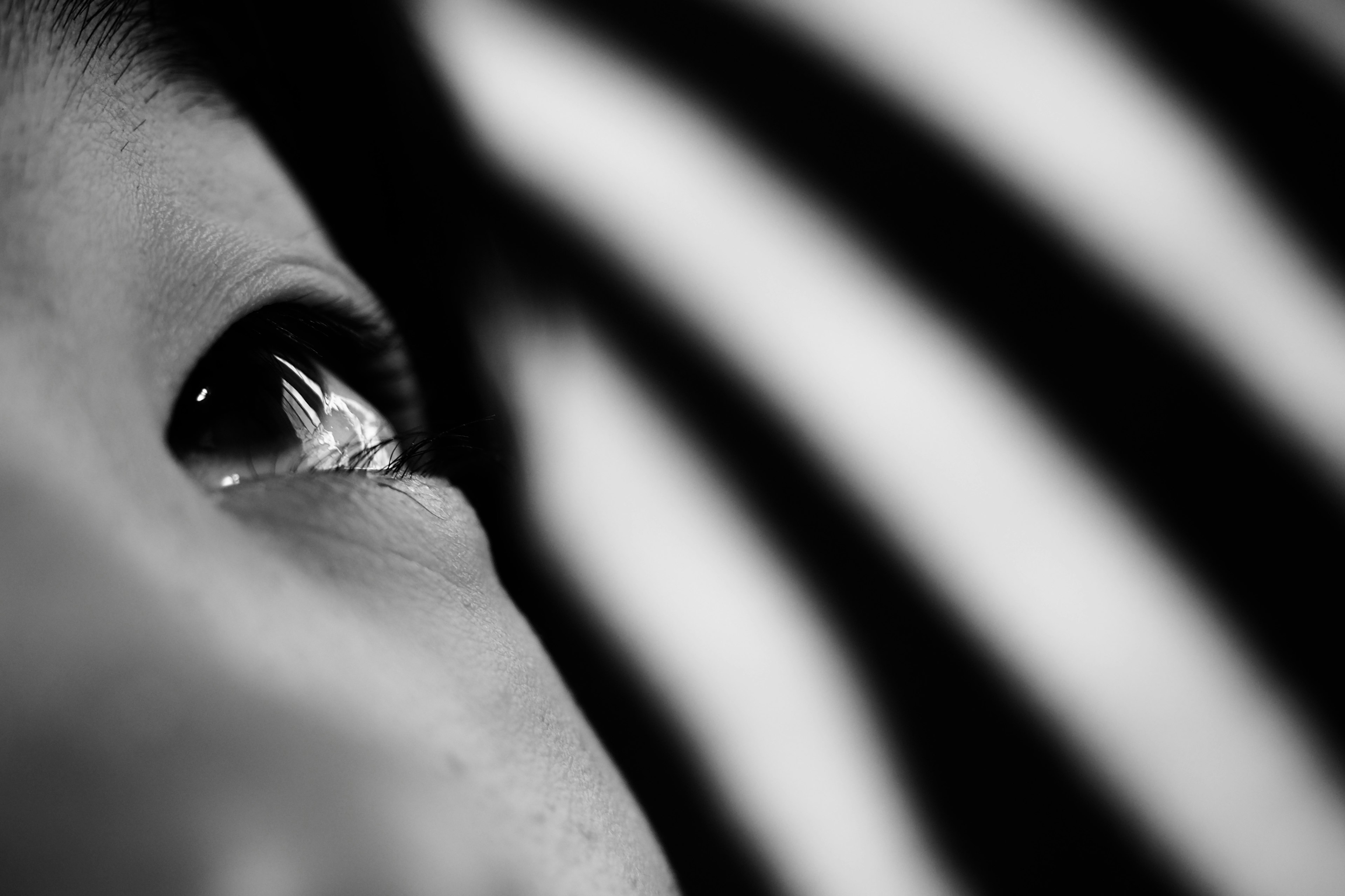 Close-up of an eye with a black and white striped background