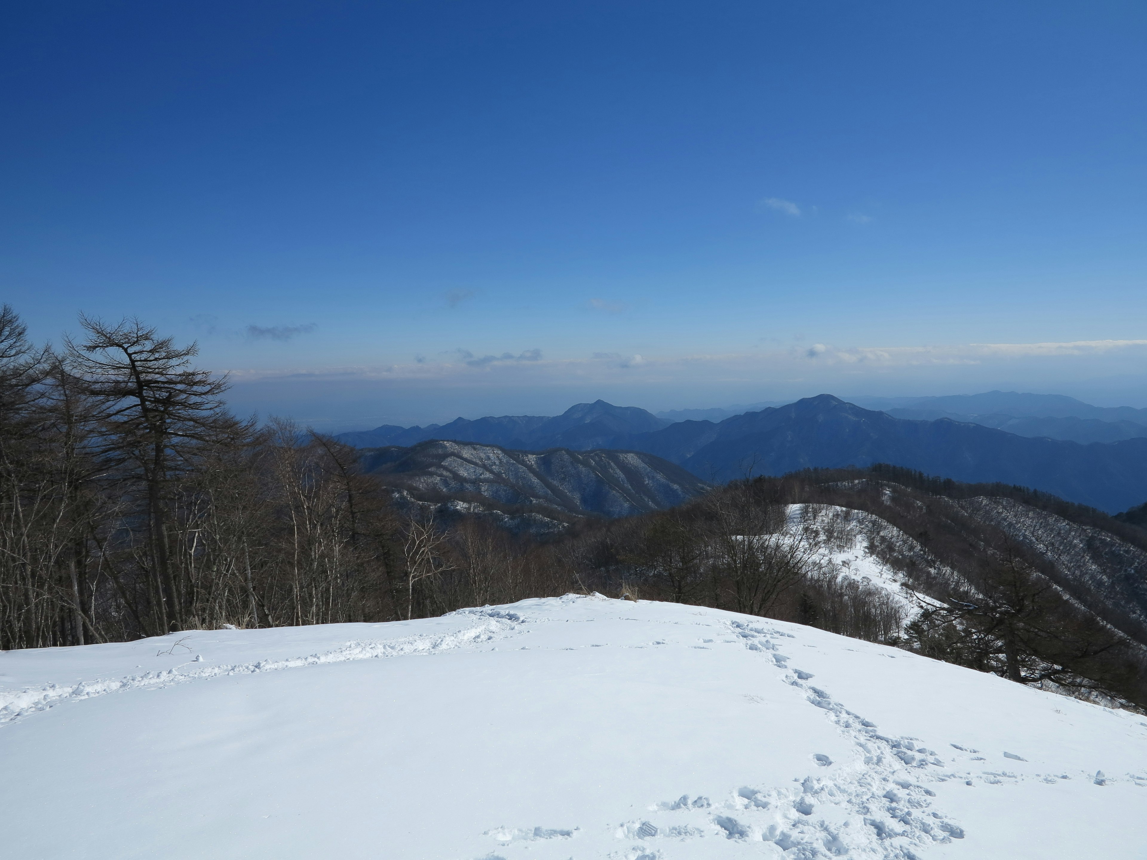 Snow-covered mountains under a clear blue sky