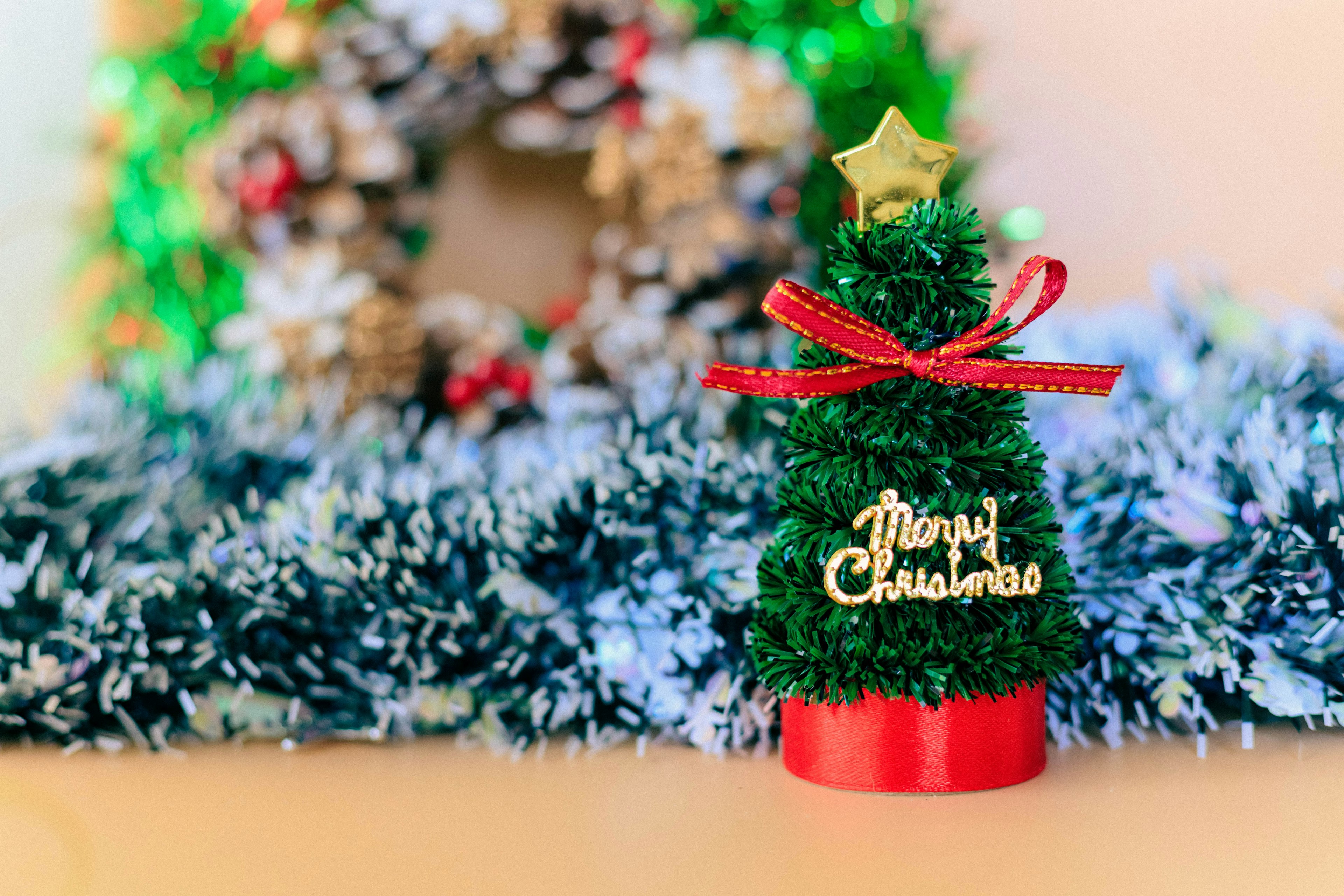 Christmas tree decoration with a wreath in the background