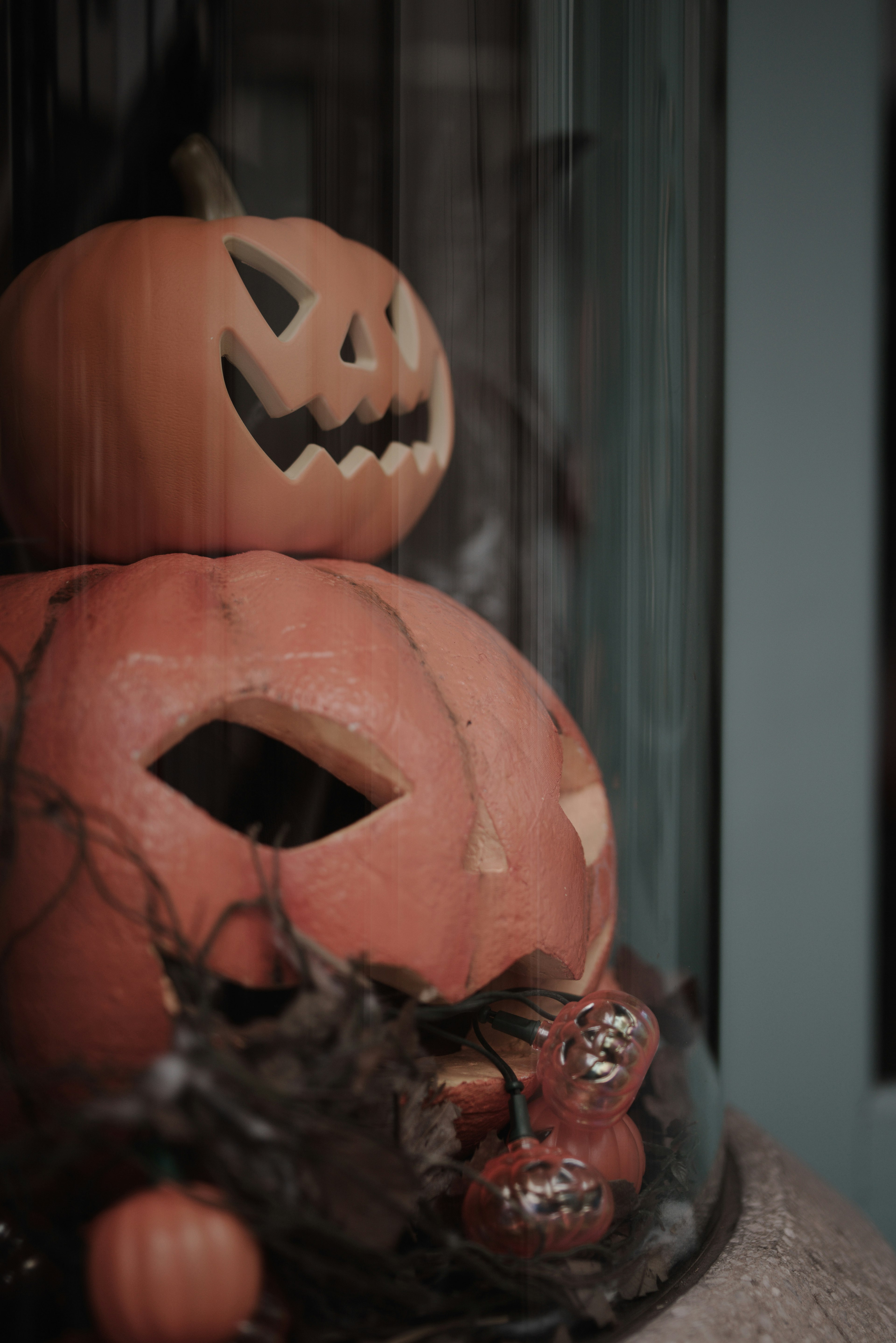 Halloween pumpkin decoration featuring carved faces and autumn elements