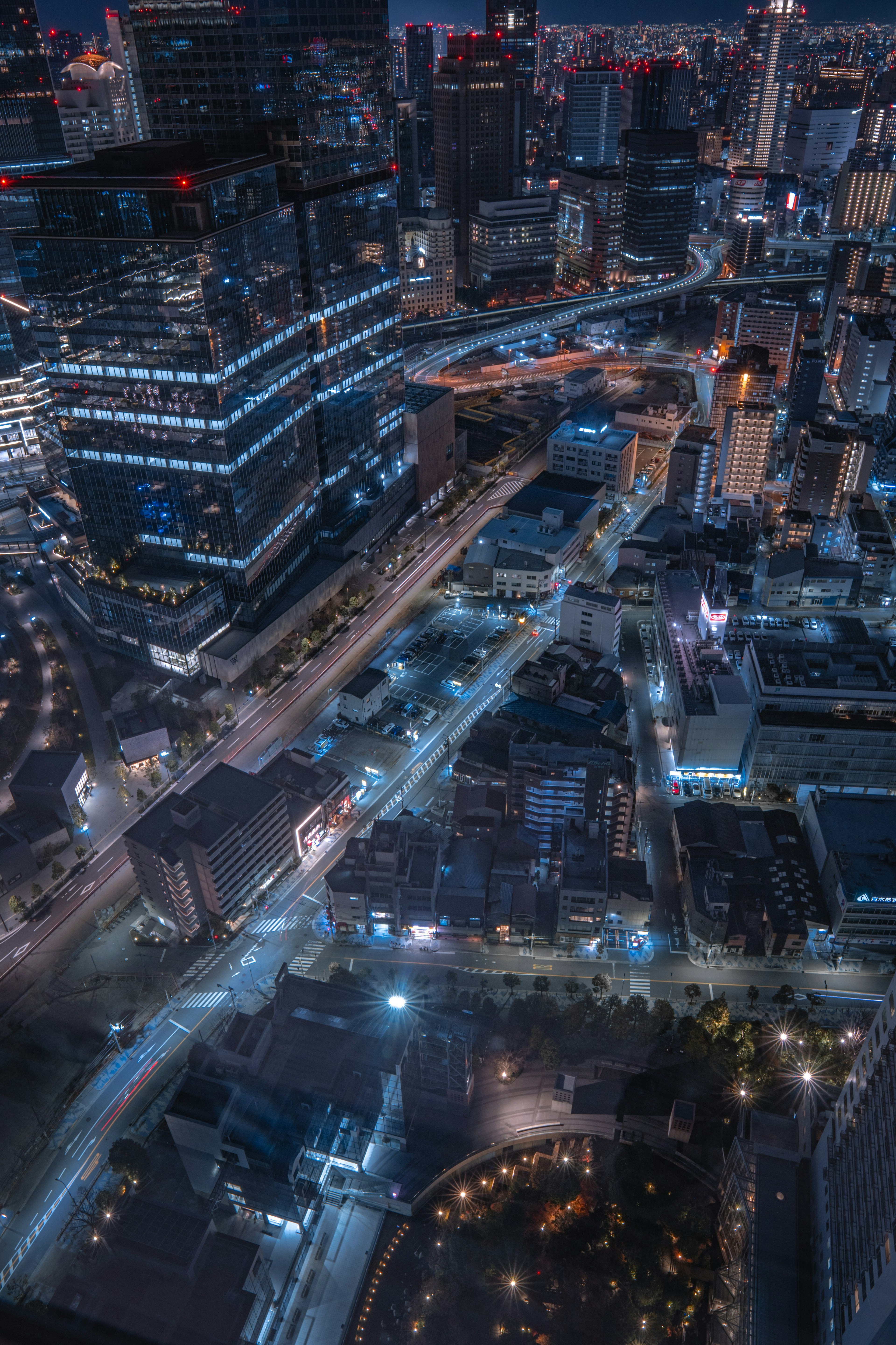 Night cityscape with illuminated skyscrapers and streets