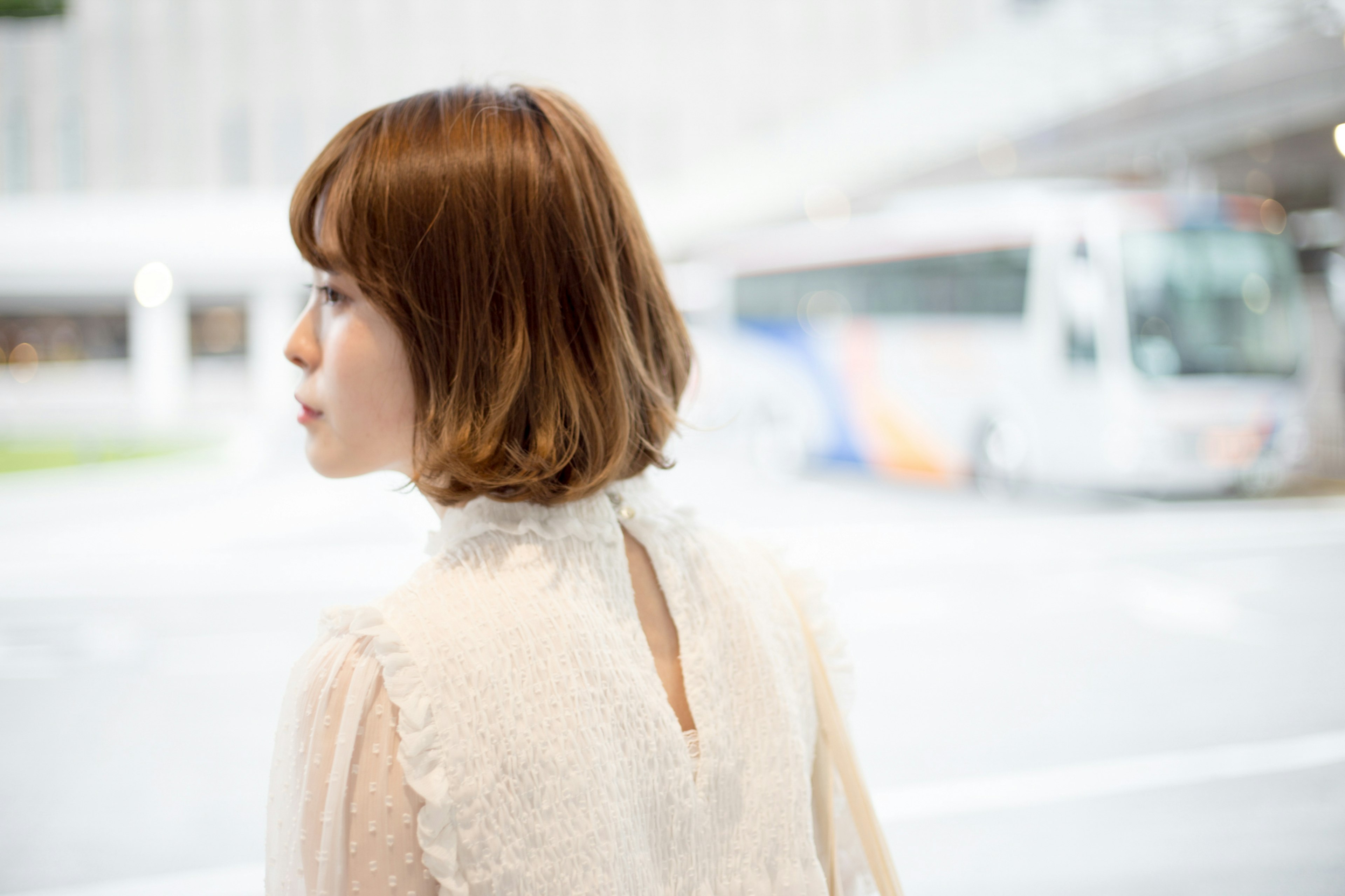 A woman looking back at a bus stop