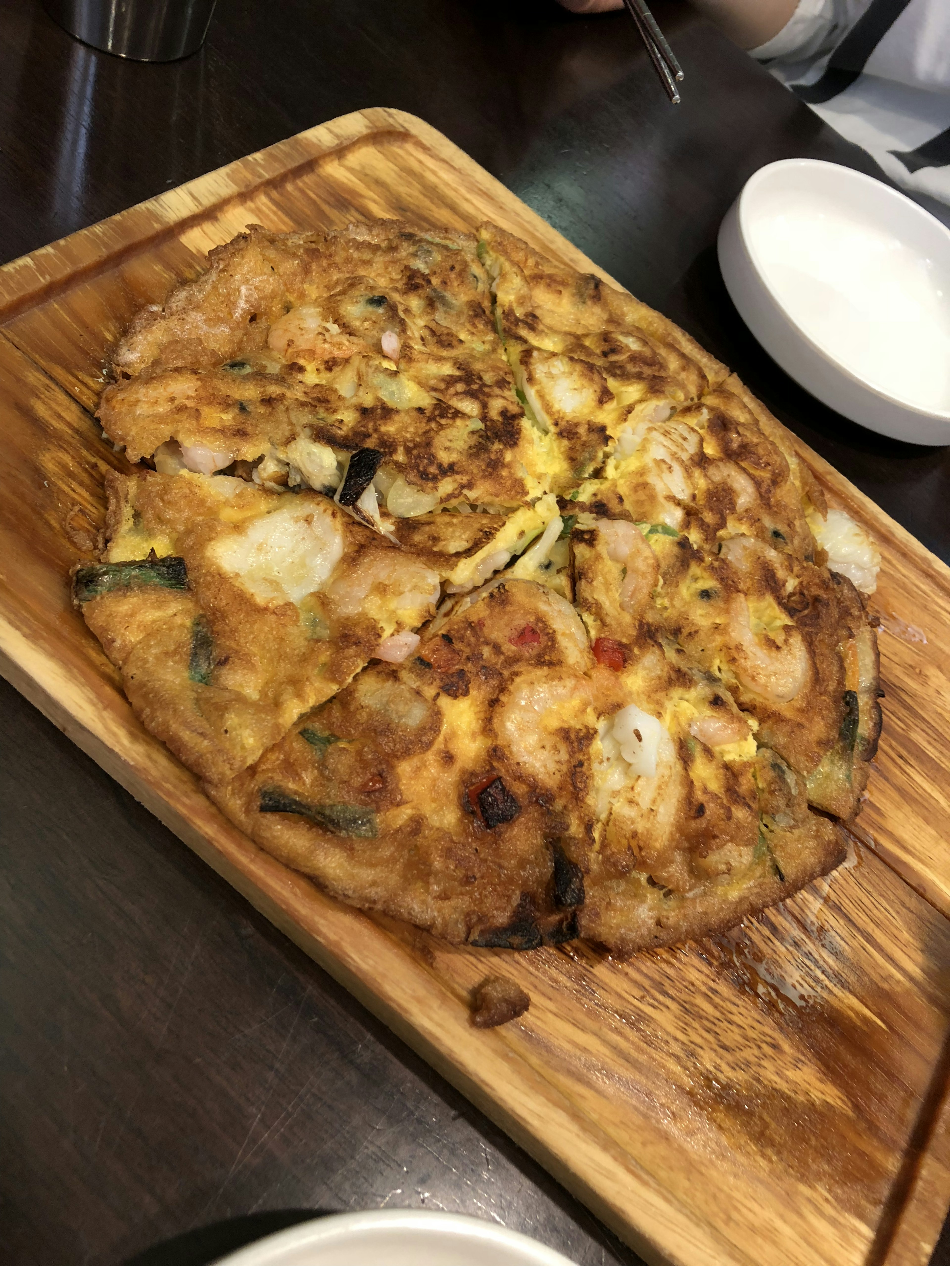 Korean seafood pancake served on a wooden platter