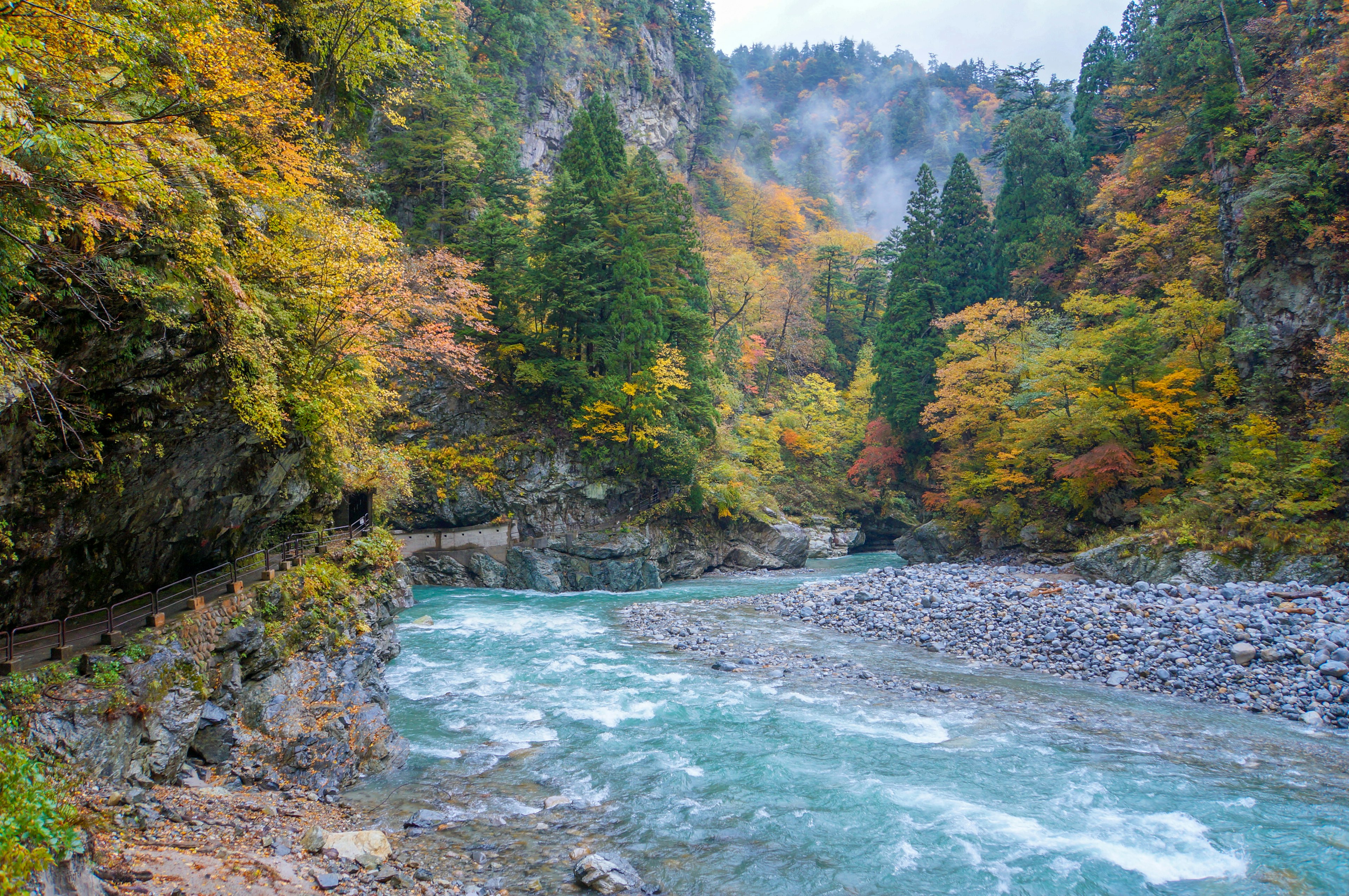 Vista panoramica di un fiume che scorre attraverso una valle con foglie autunnali