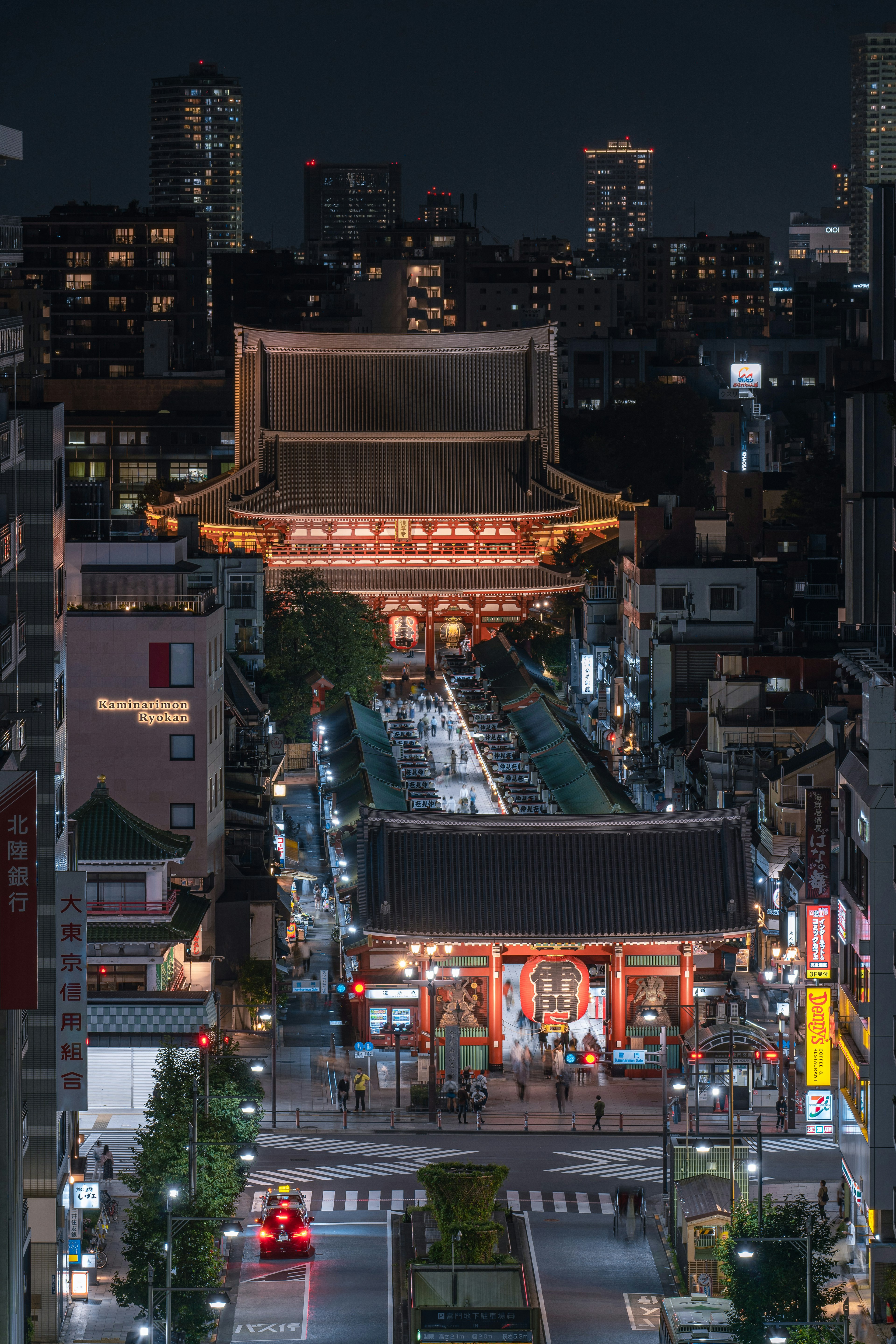 Senso-ji Temple illuminated at night with surrounding cityscape in Tokyo