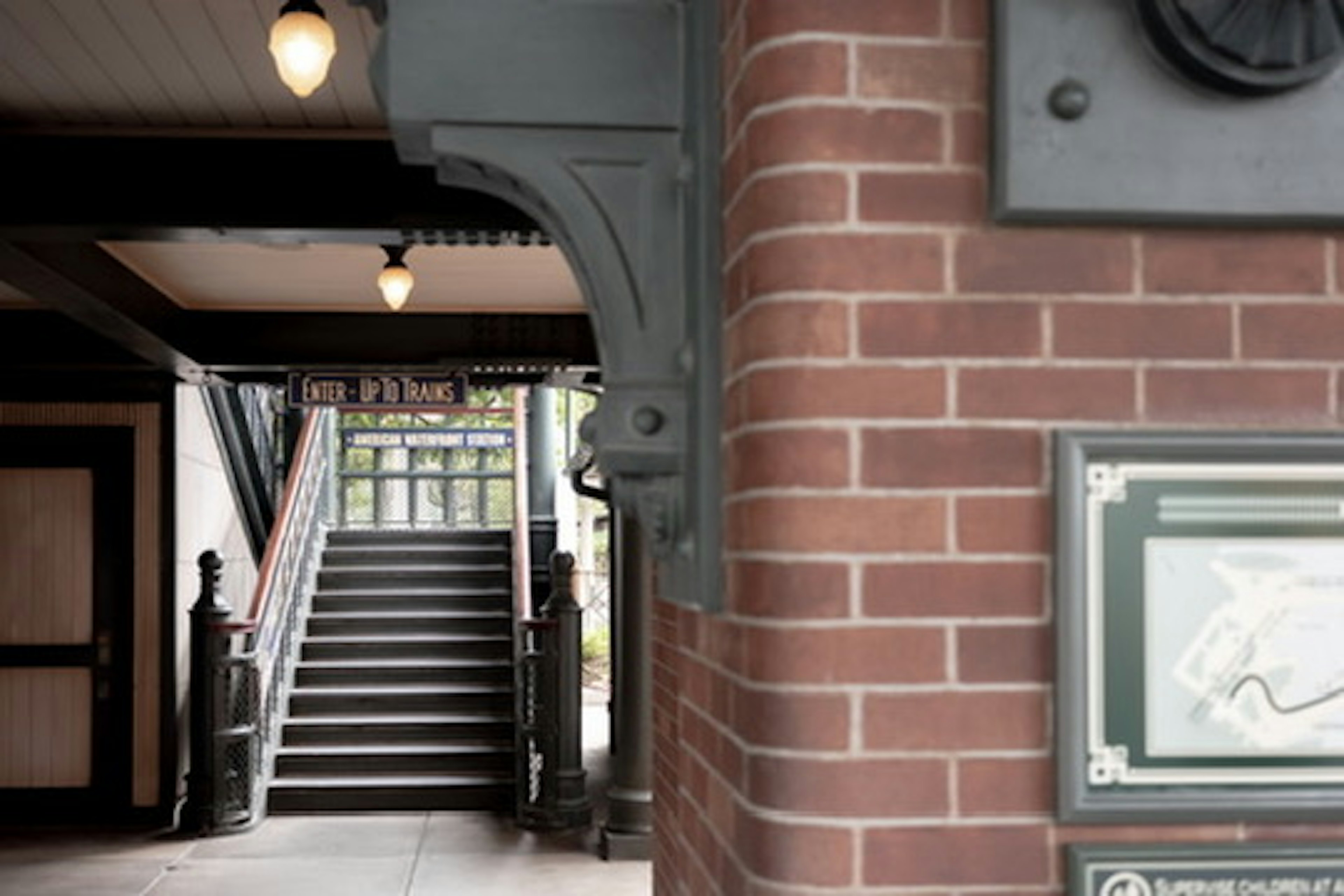 Interior of a building featuring a staircase and brick column