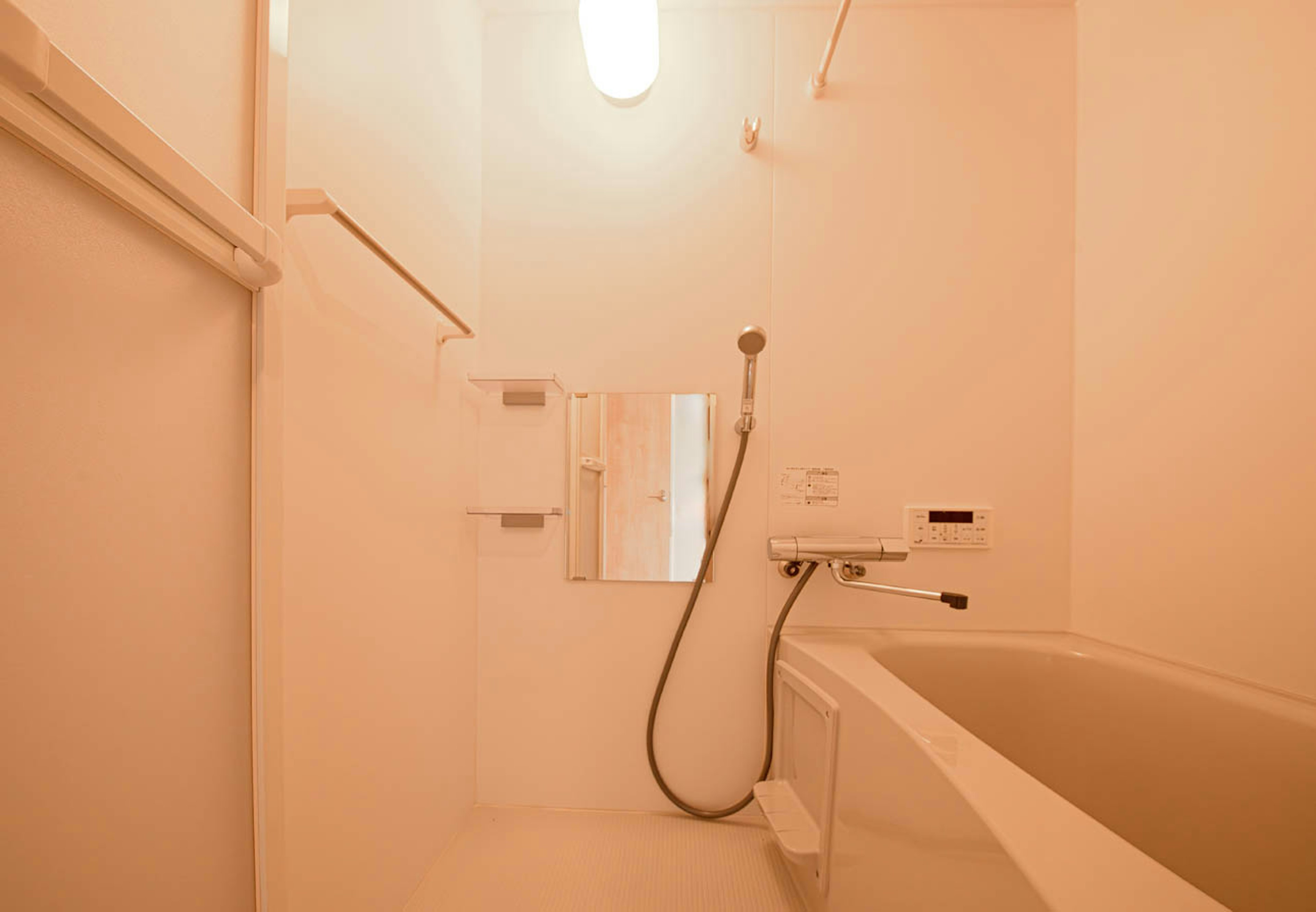 Brightly lit bathroom scene featuring a shower and bathtub