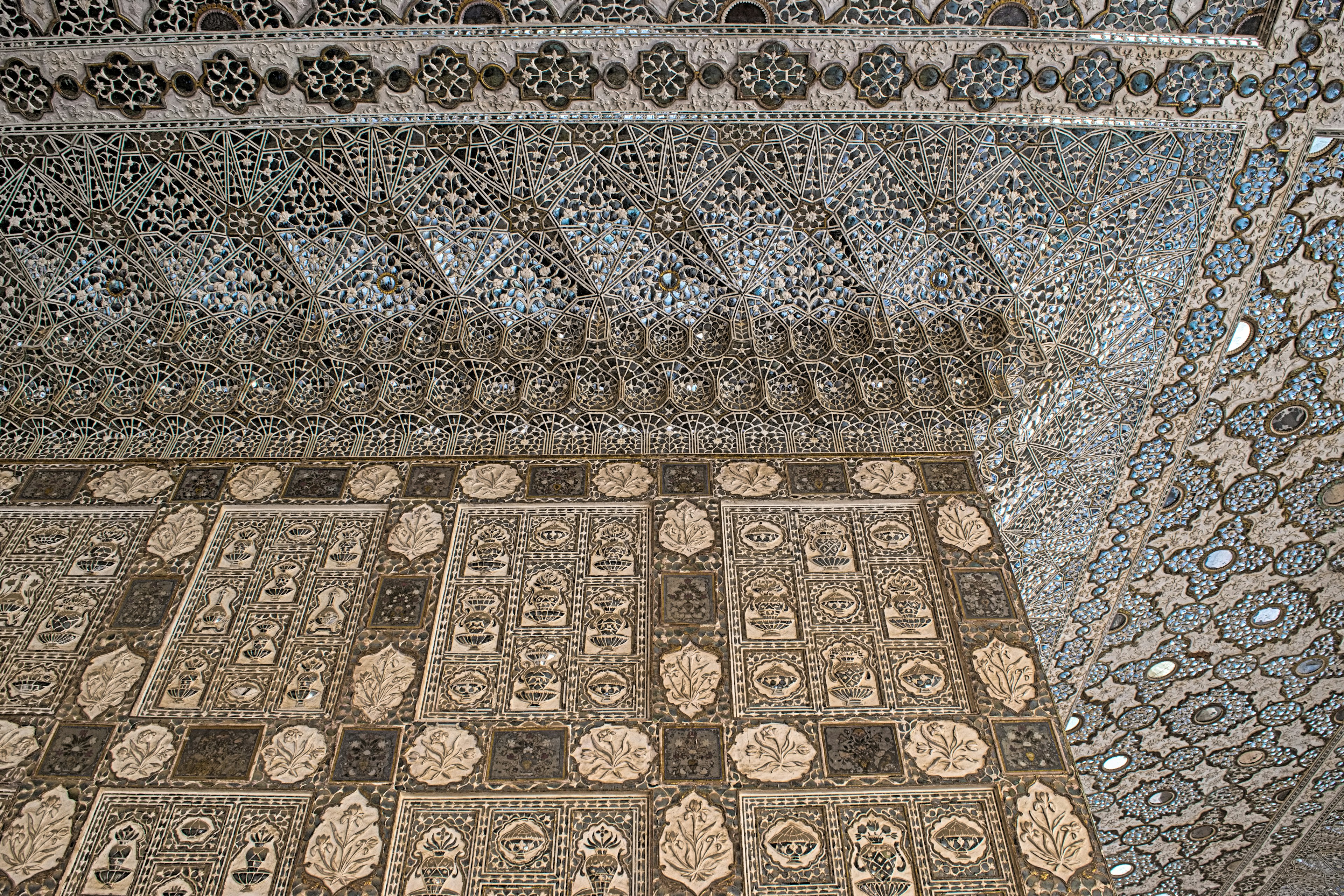 Intricate mosaic tile patterns on wall and floor showcasing detailed craftsmanship