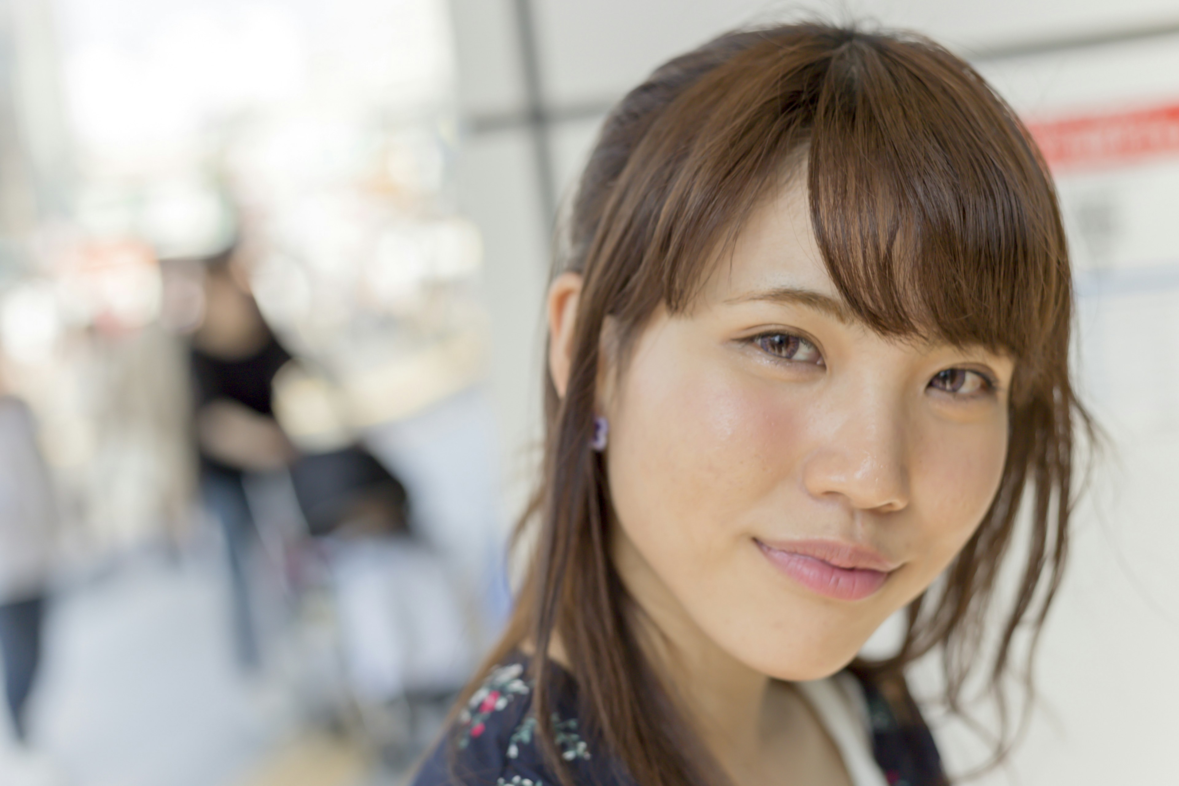 A young woman smiling in an urban setting