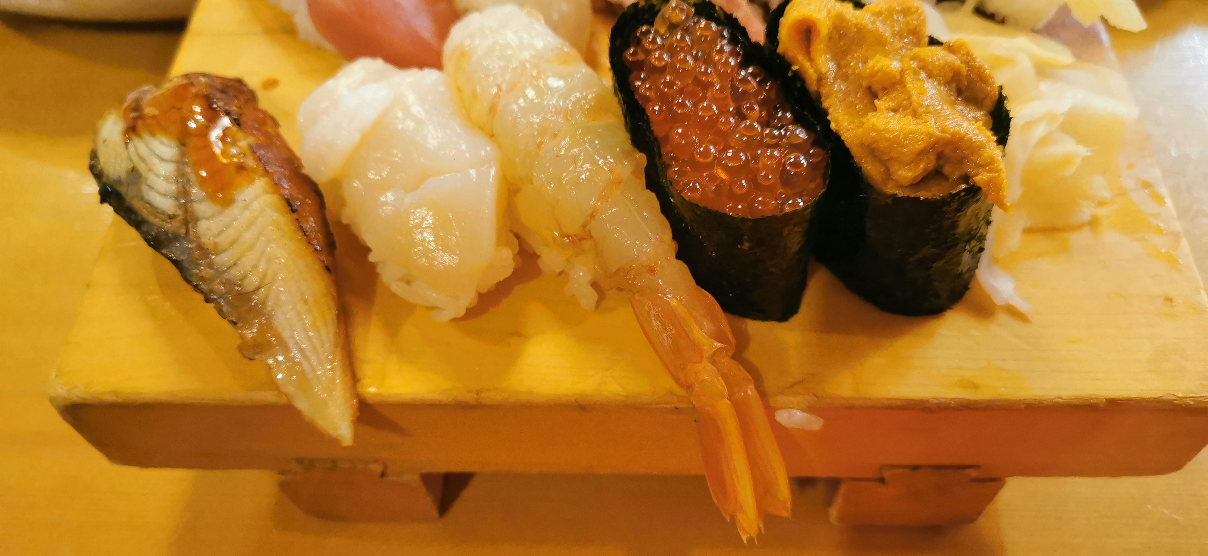 Assorted fresh sushi on a wooden plate