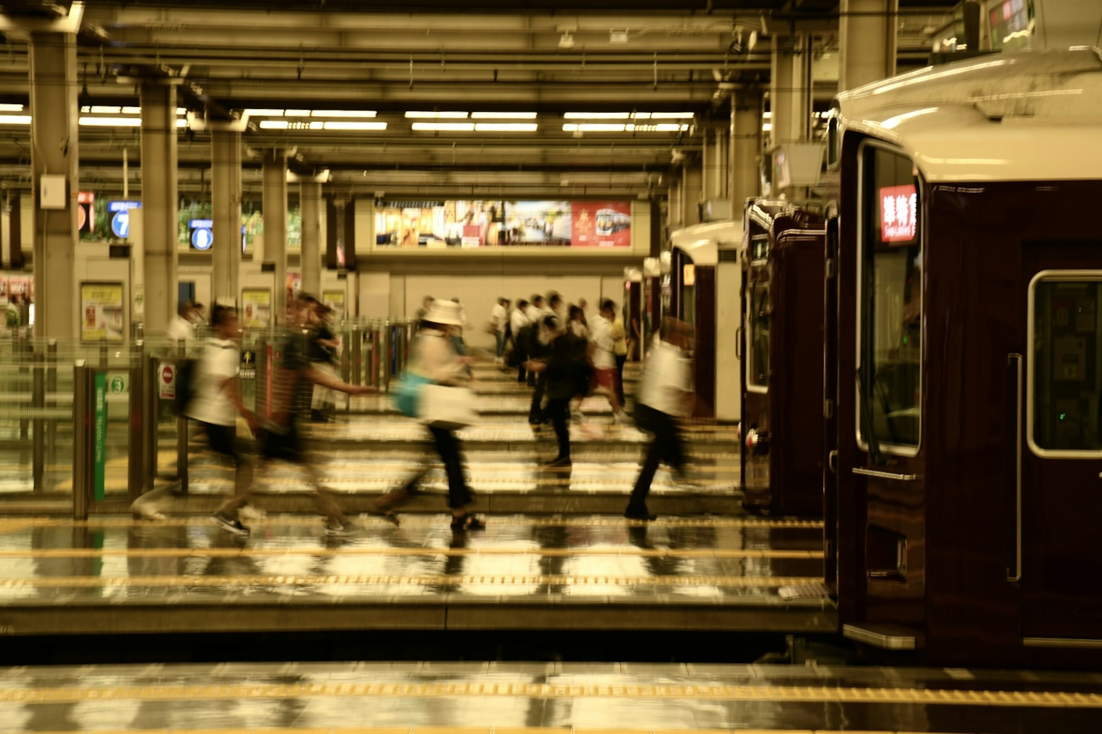 Crowded train station platform with blurred commuters and a train