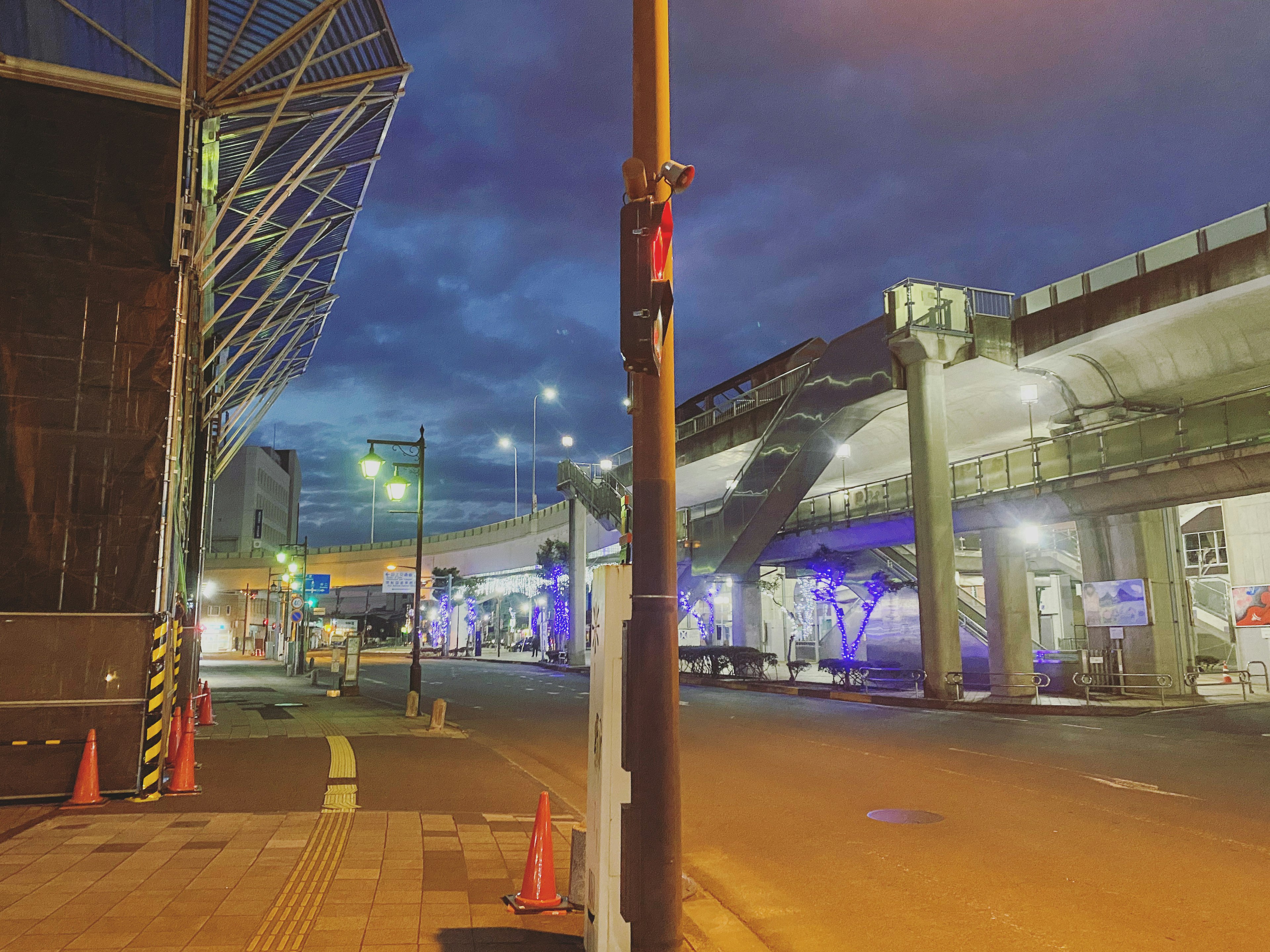 Nighttime cityscape with an elevated bridge Streetlights illuminating the area