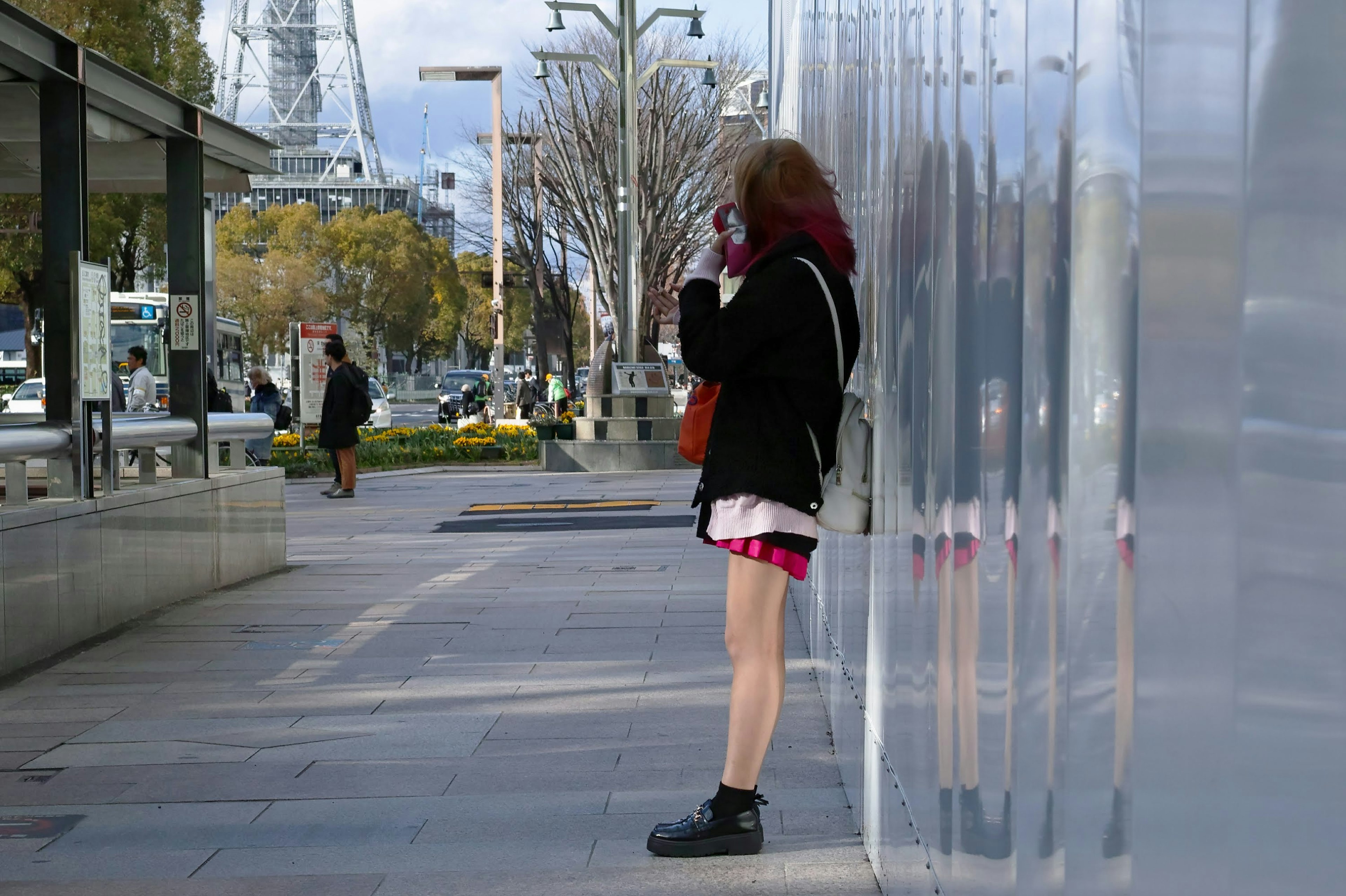 一名女性在城市環境中站著使用智能手機