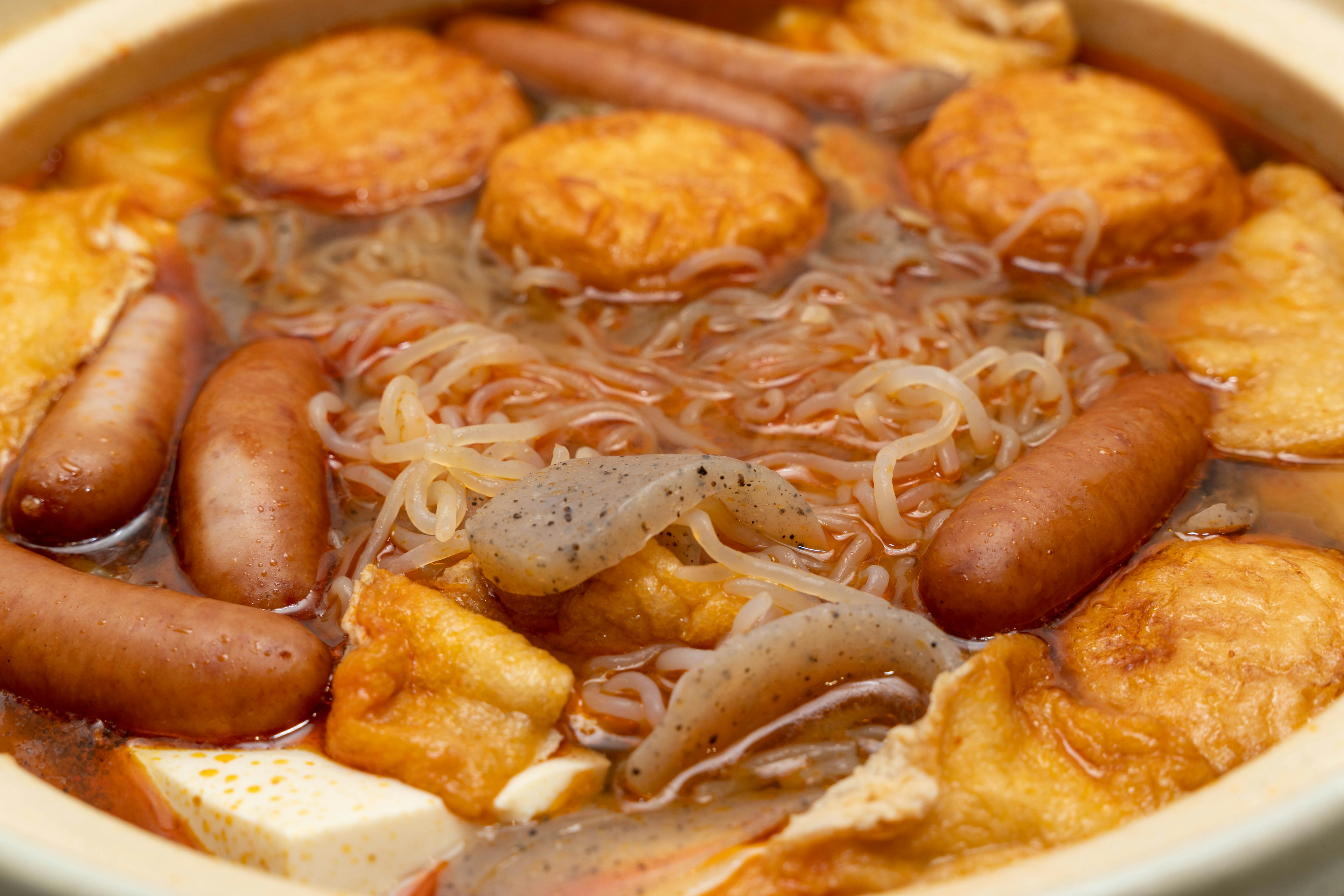 Warm soup with various ingredients in a pot