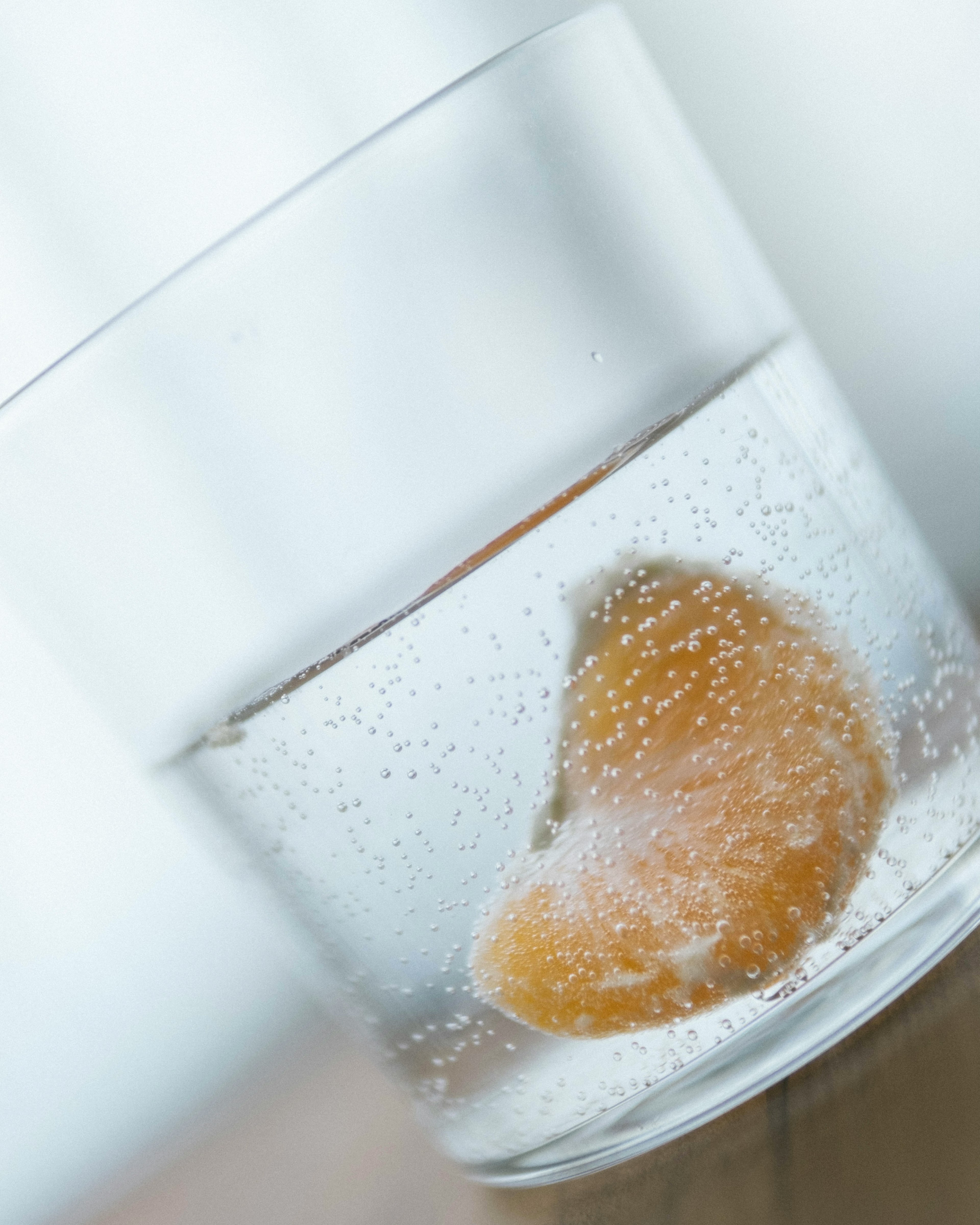 Glass of sparkling water with a slice of orange