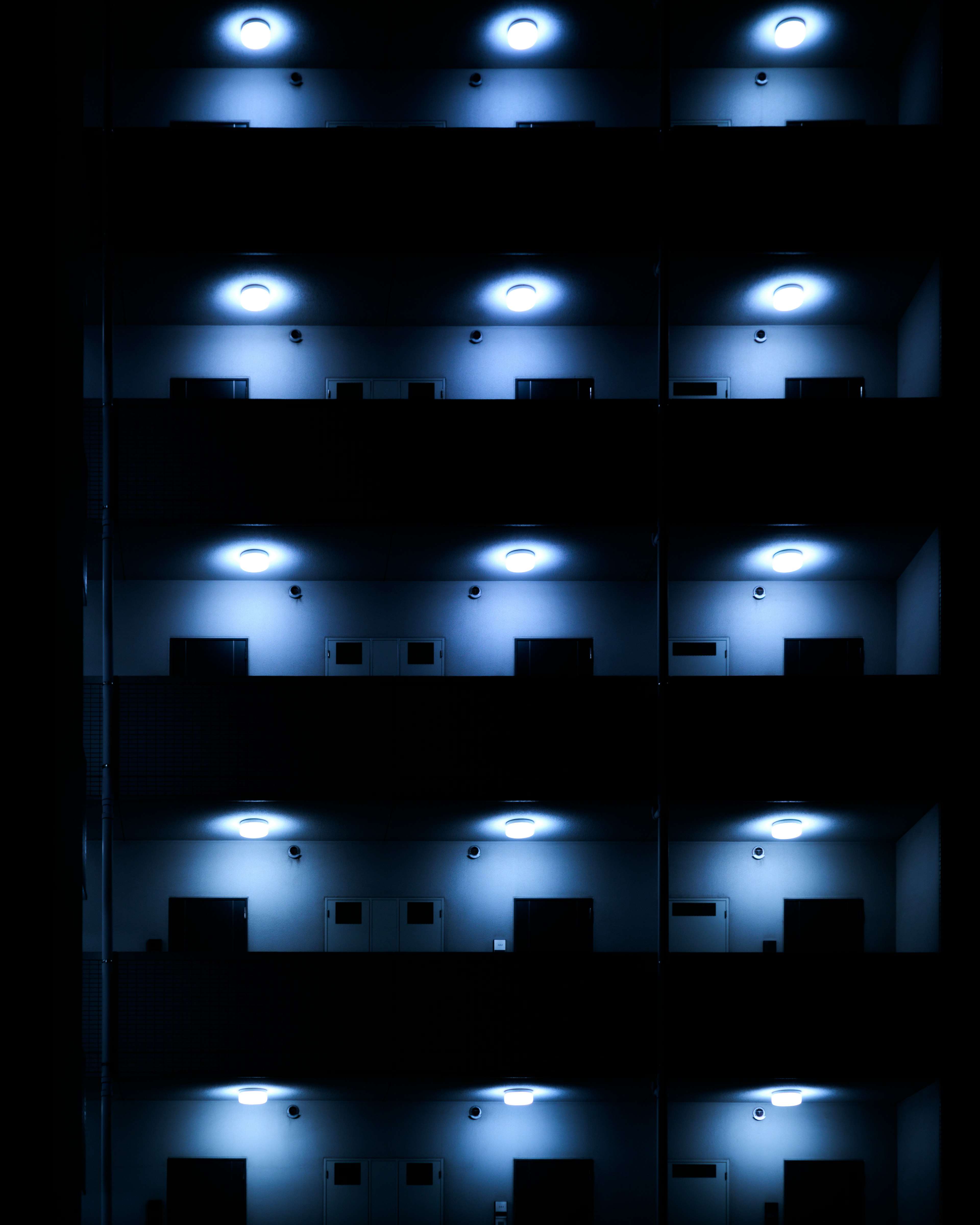 Close-up of a building facade illuminated by blue lights