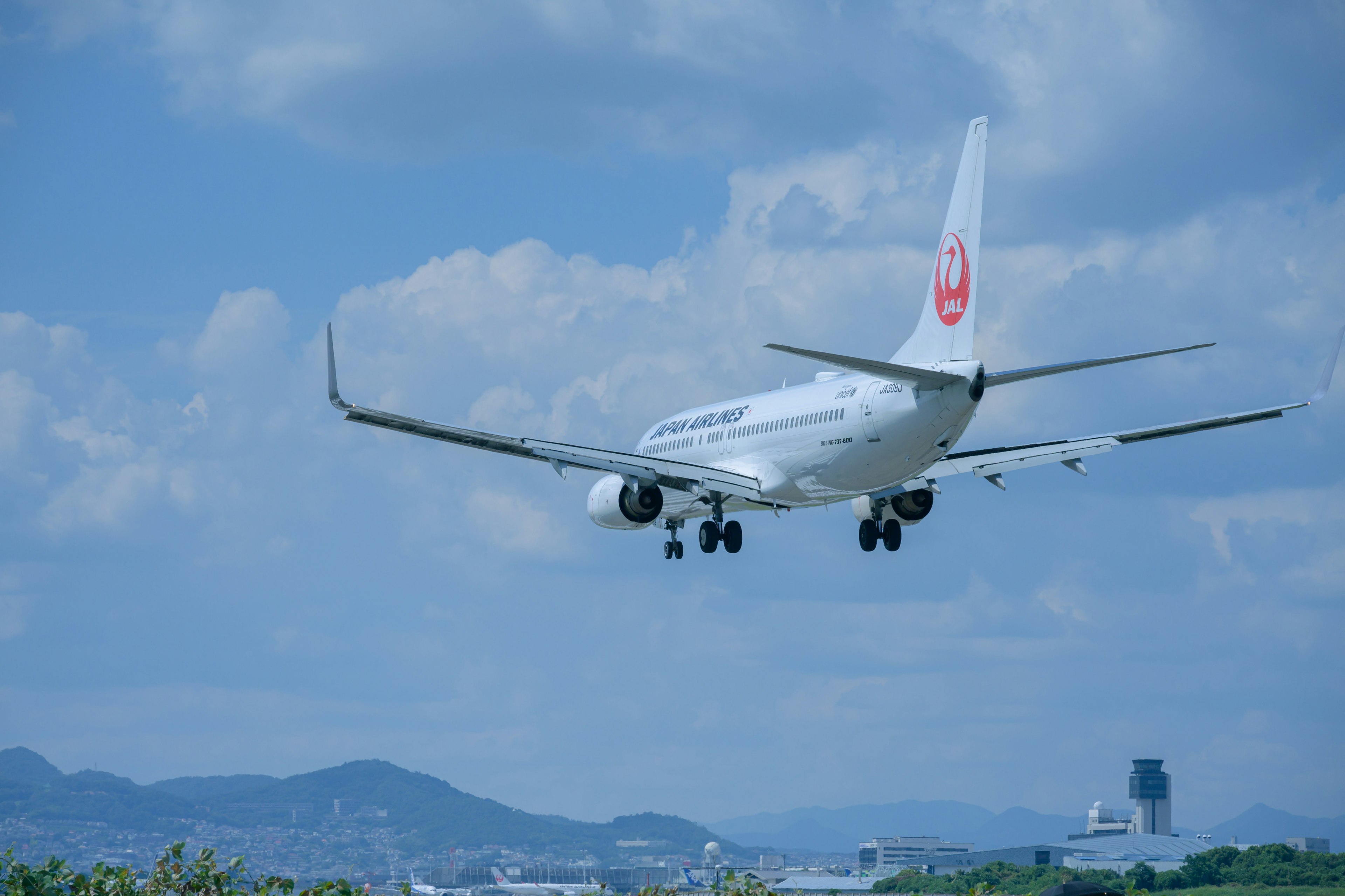 White airplane landing against a blue sky