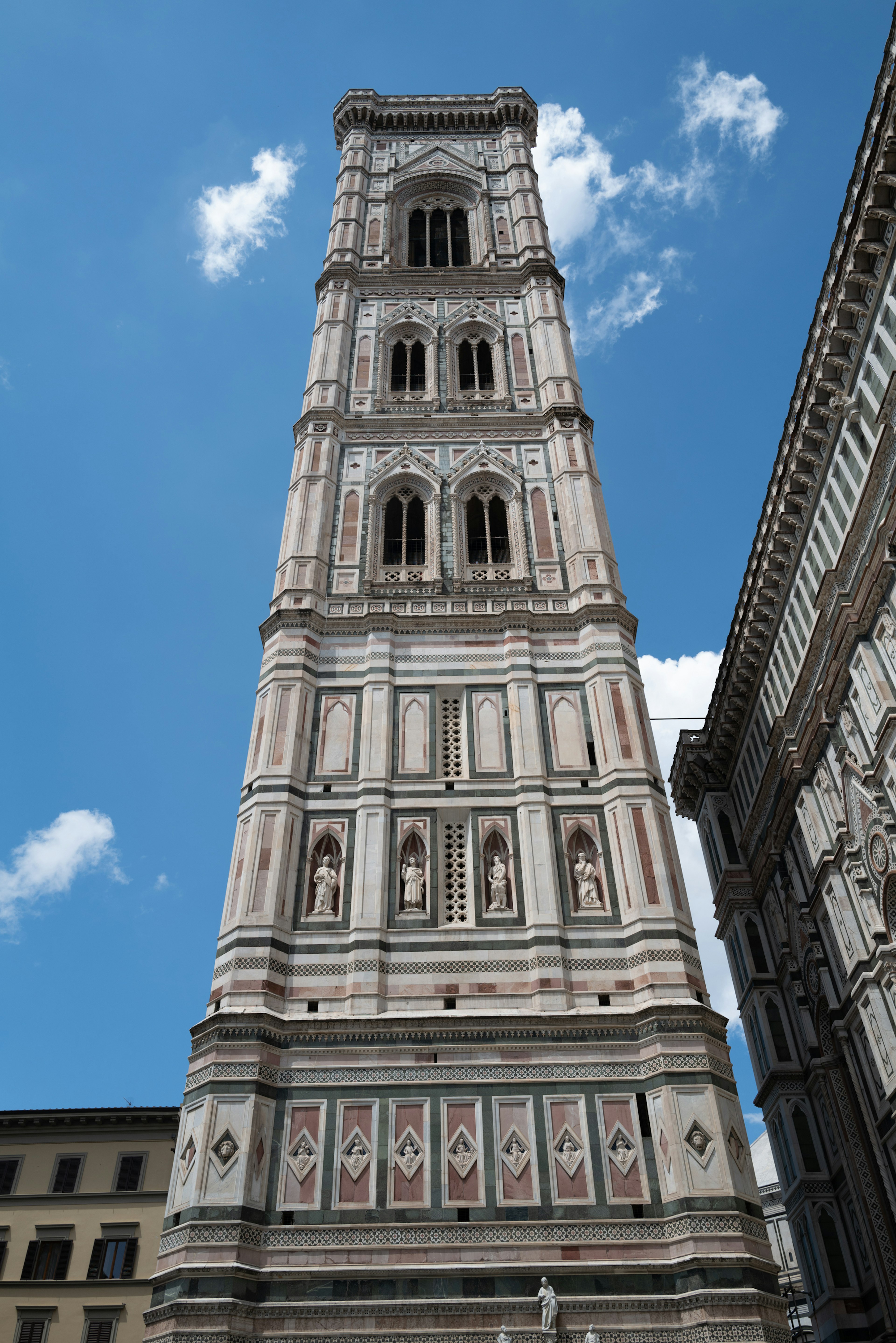 Giotto's Campanile in Florence with ornate stone facade and blue sky