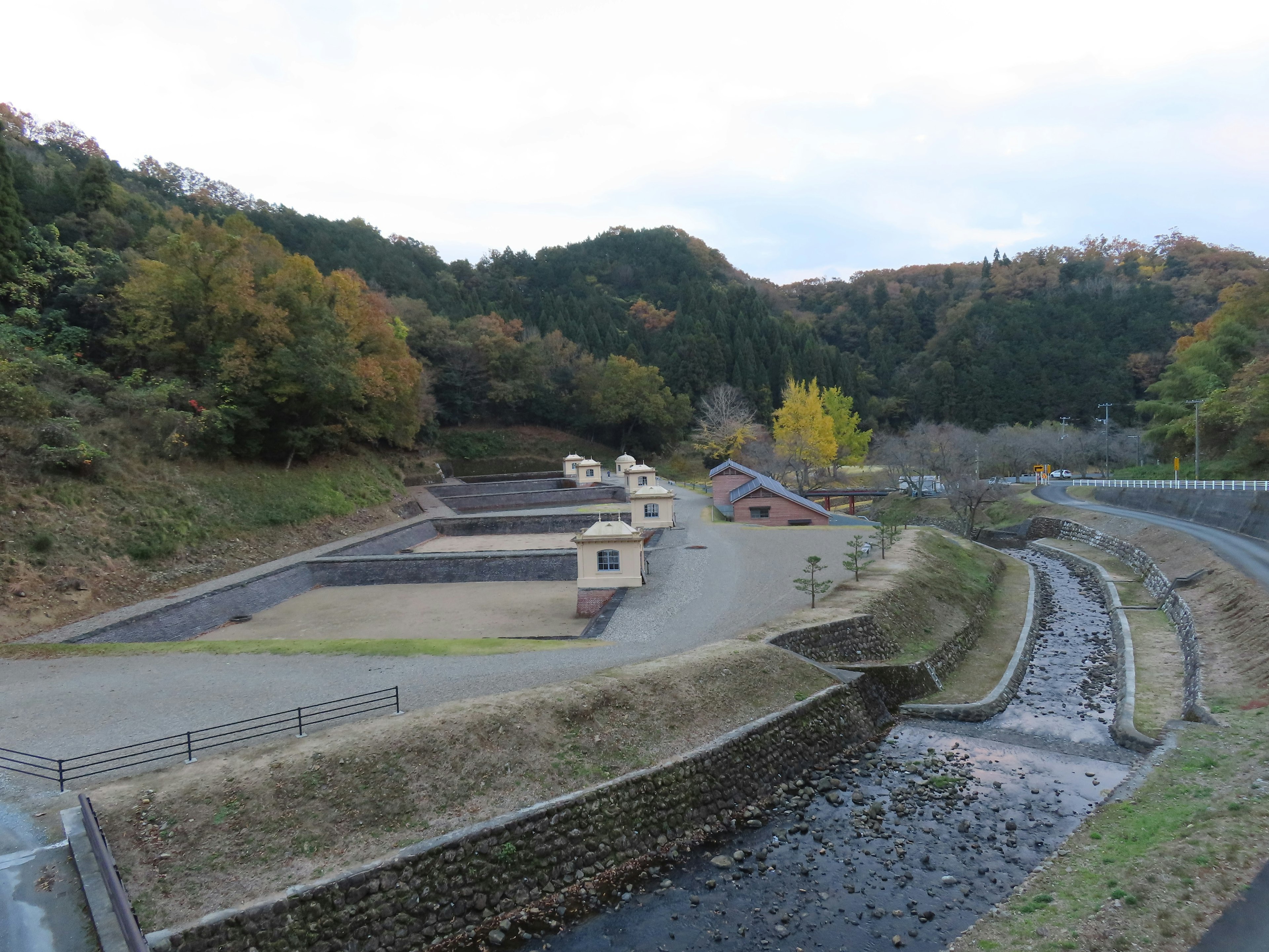 Scenic view of a small village surrounded by hills and a quiet river