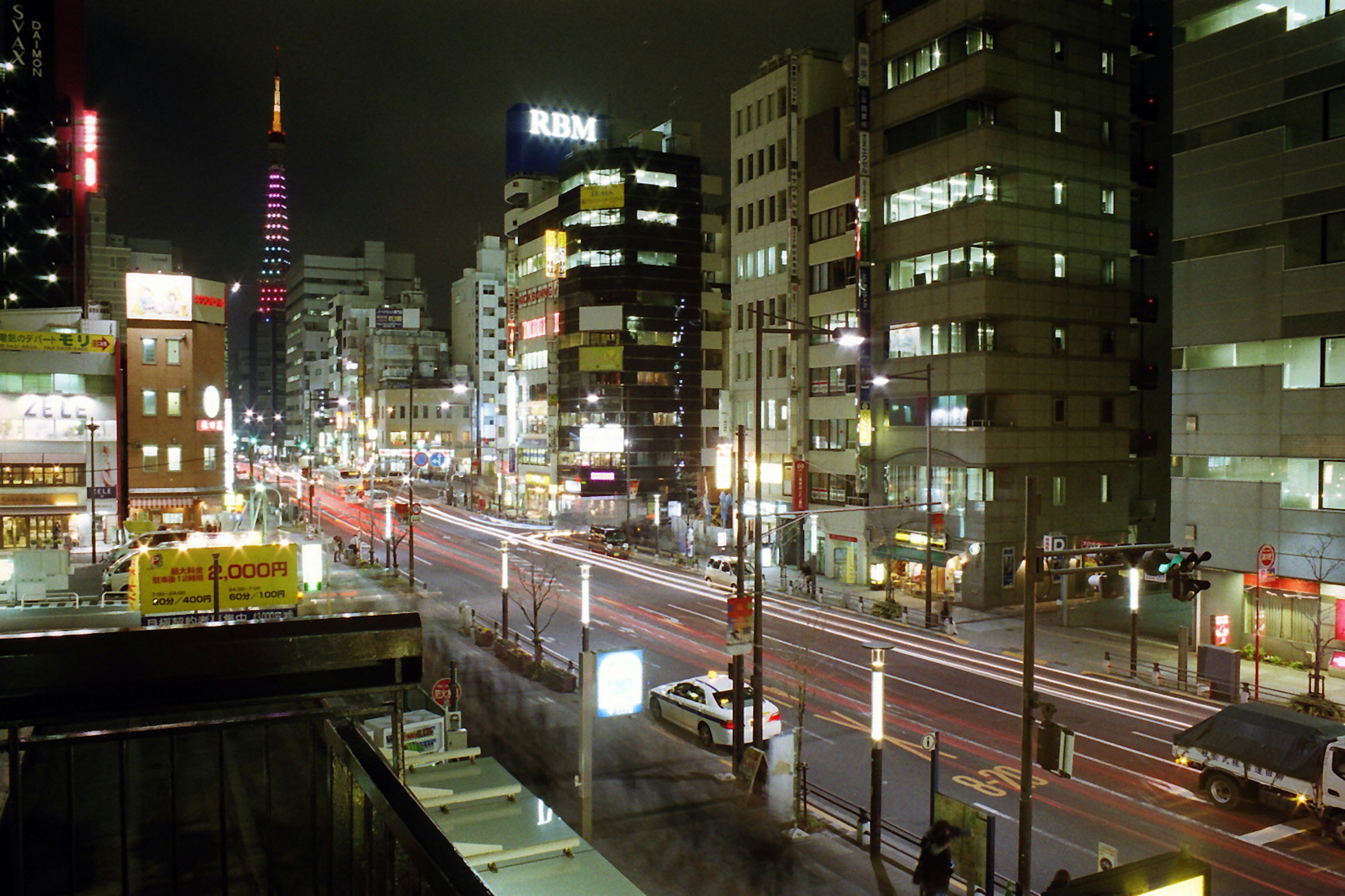 Night view of Tokyo cityscape with bright signs and car lights