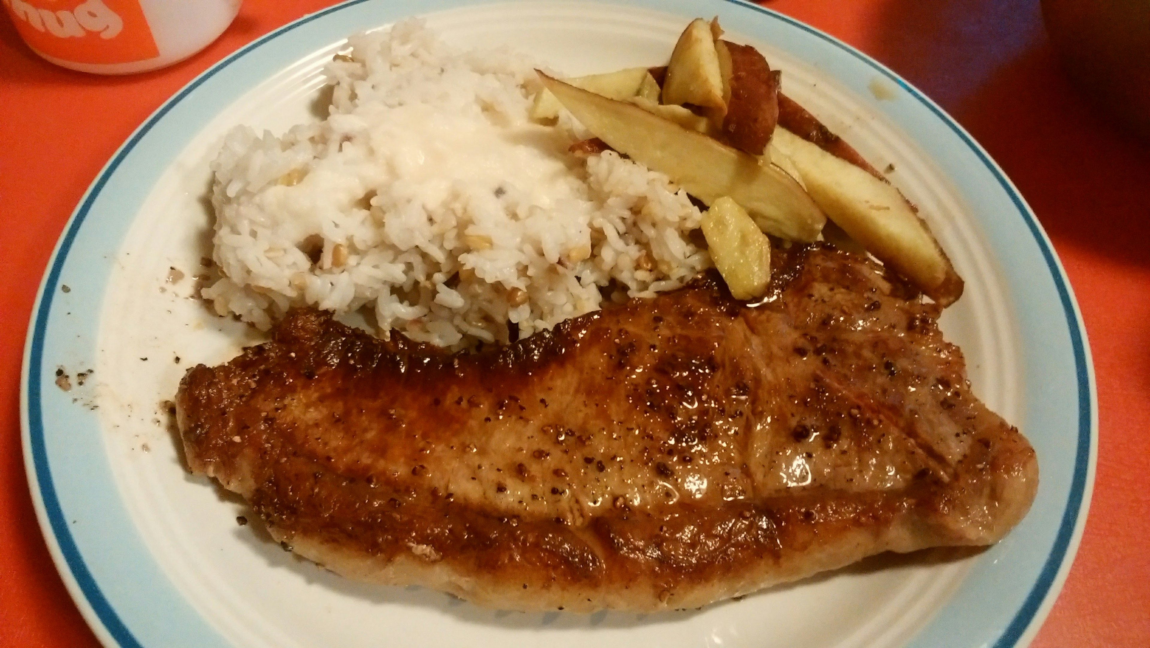 Juicy steak served with creamy mashed potatoes and sliced apples on a plate