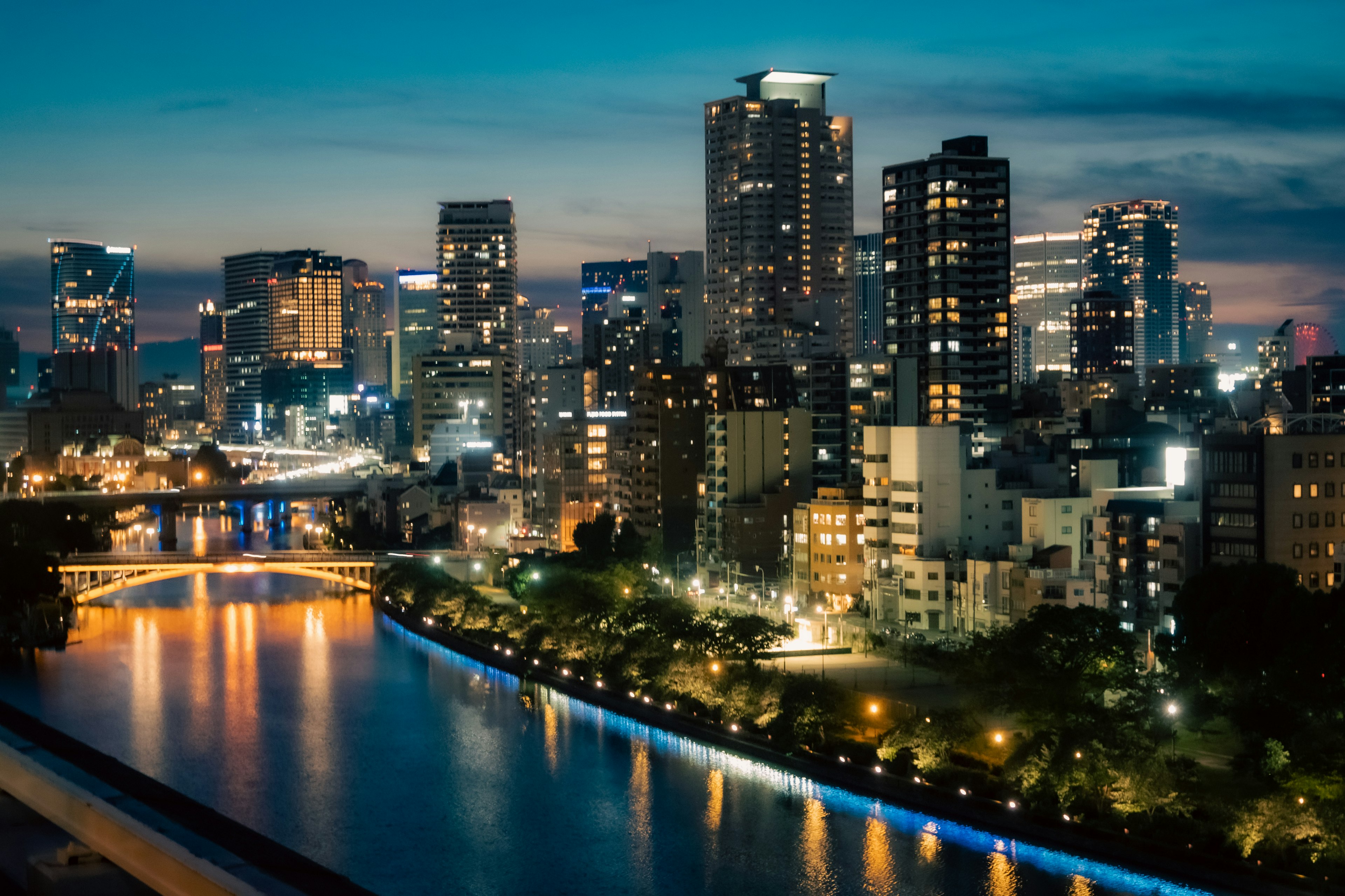 Night view of city skyline with skyscrapers and river