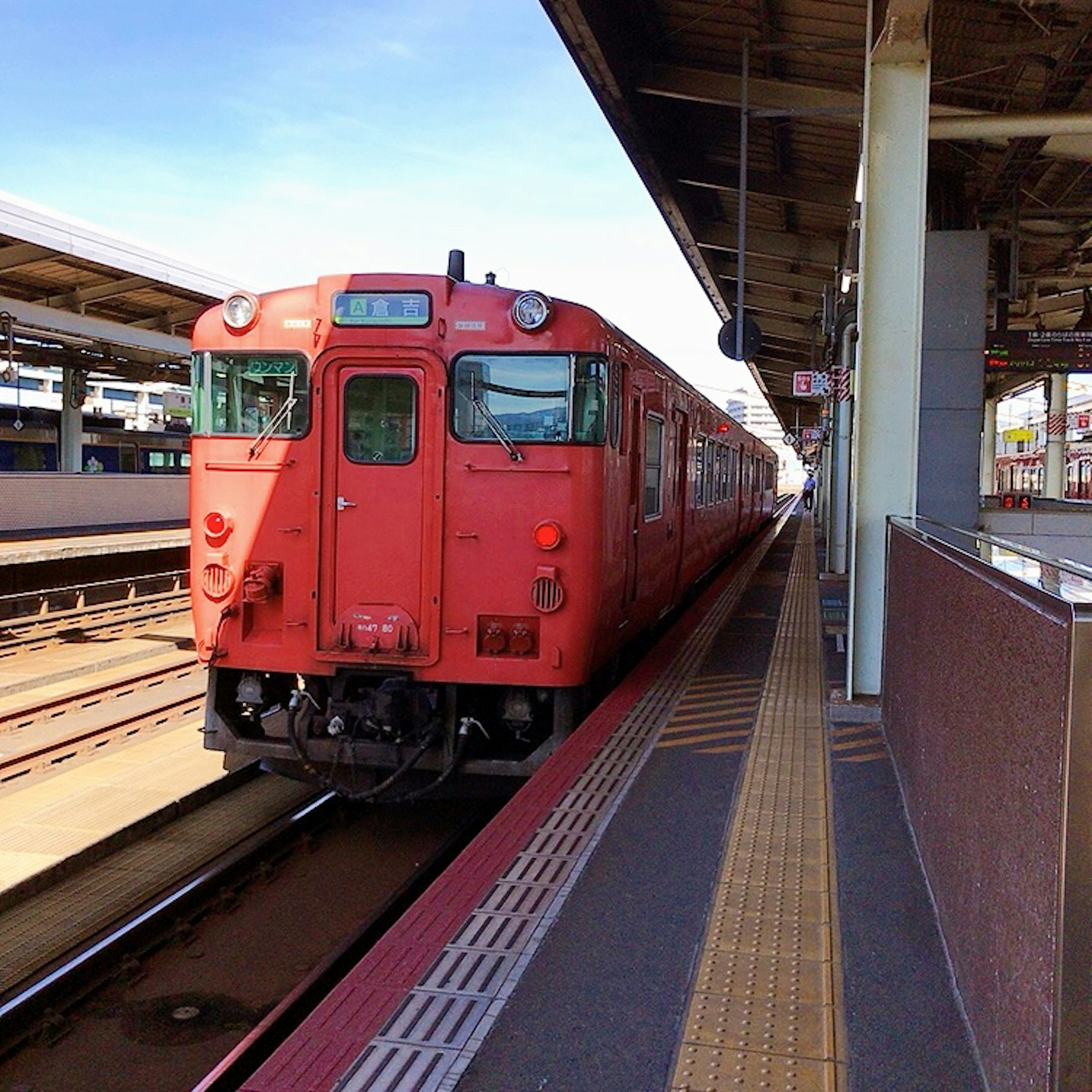 Red train stopped at a railway station