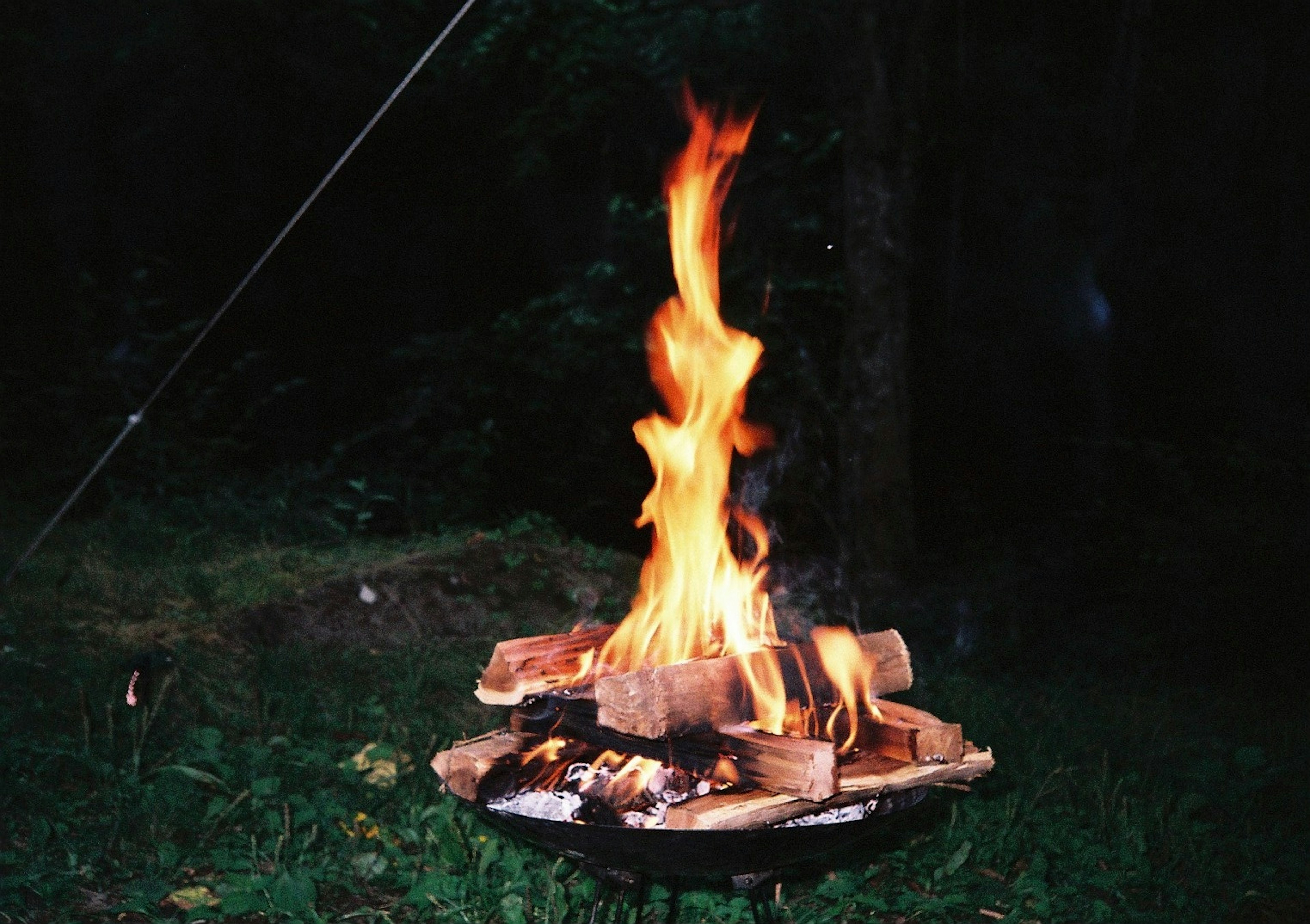 Night scene with a campfire flames rising high