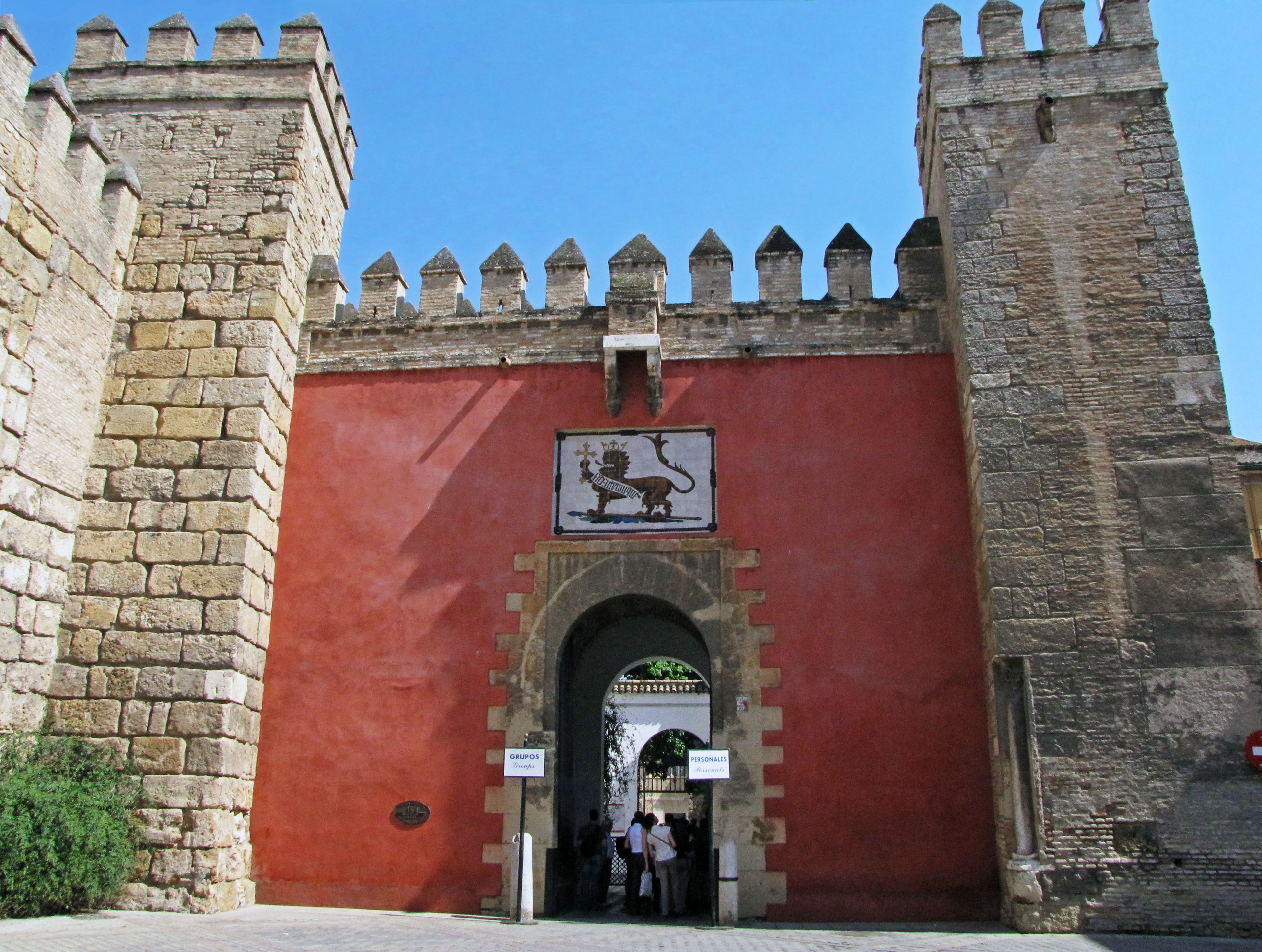 Historic building featuring a red wall castle gate and stone towers