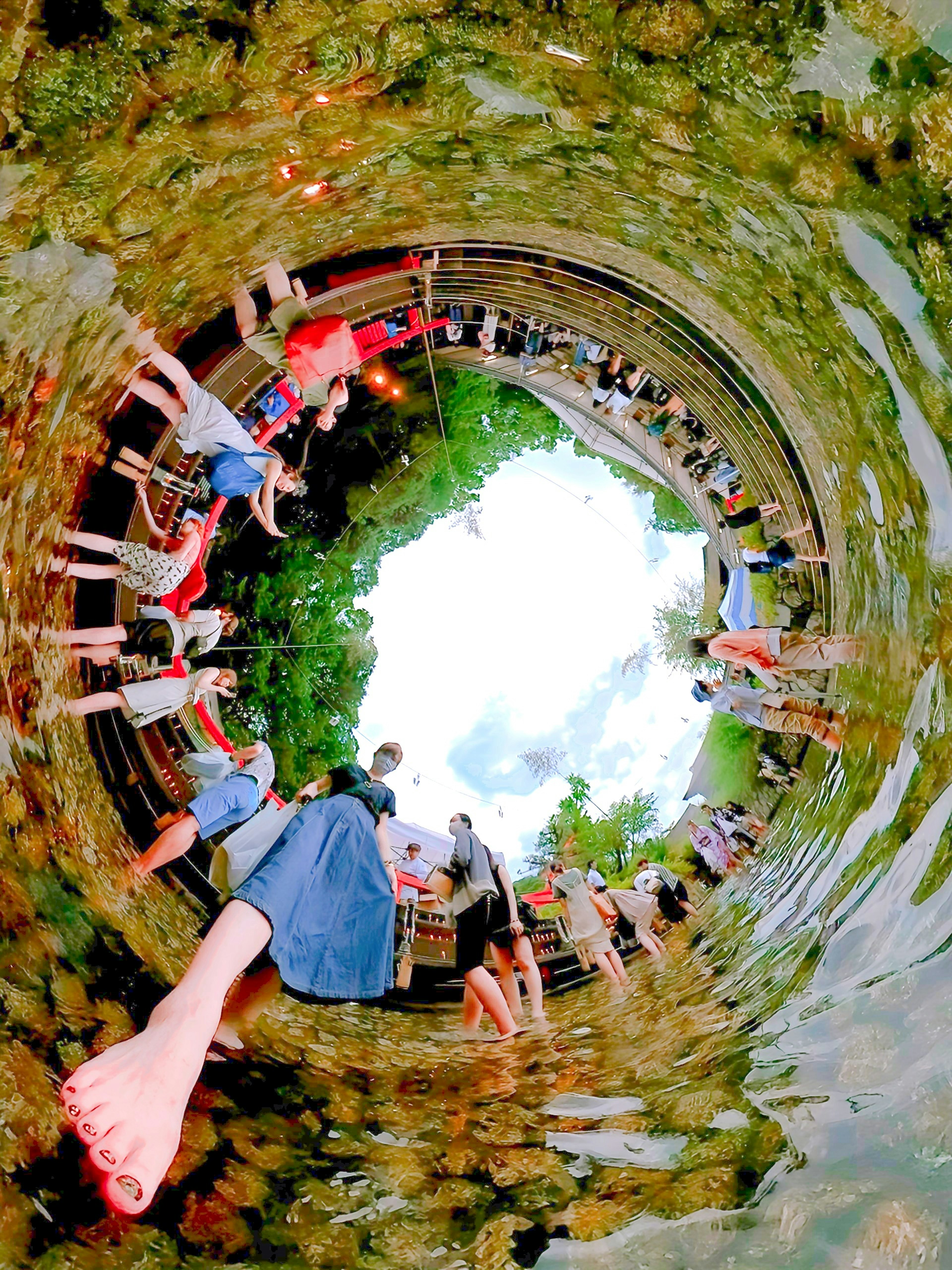 Panoramic image of many people enjoying by the water