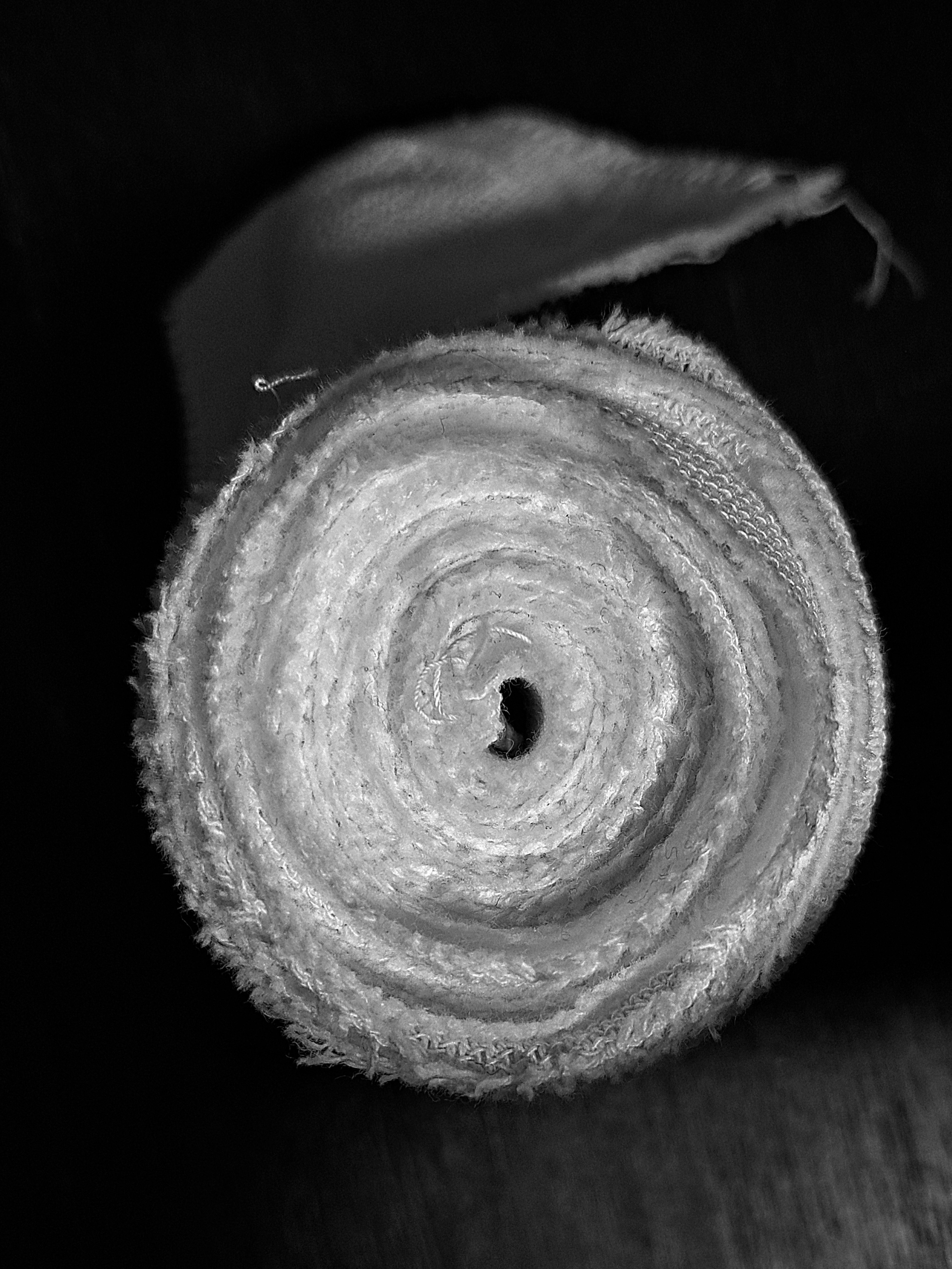 Close-up of a rolled towel on a black and white background