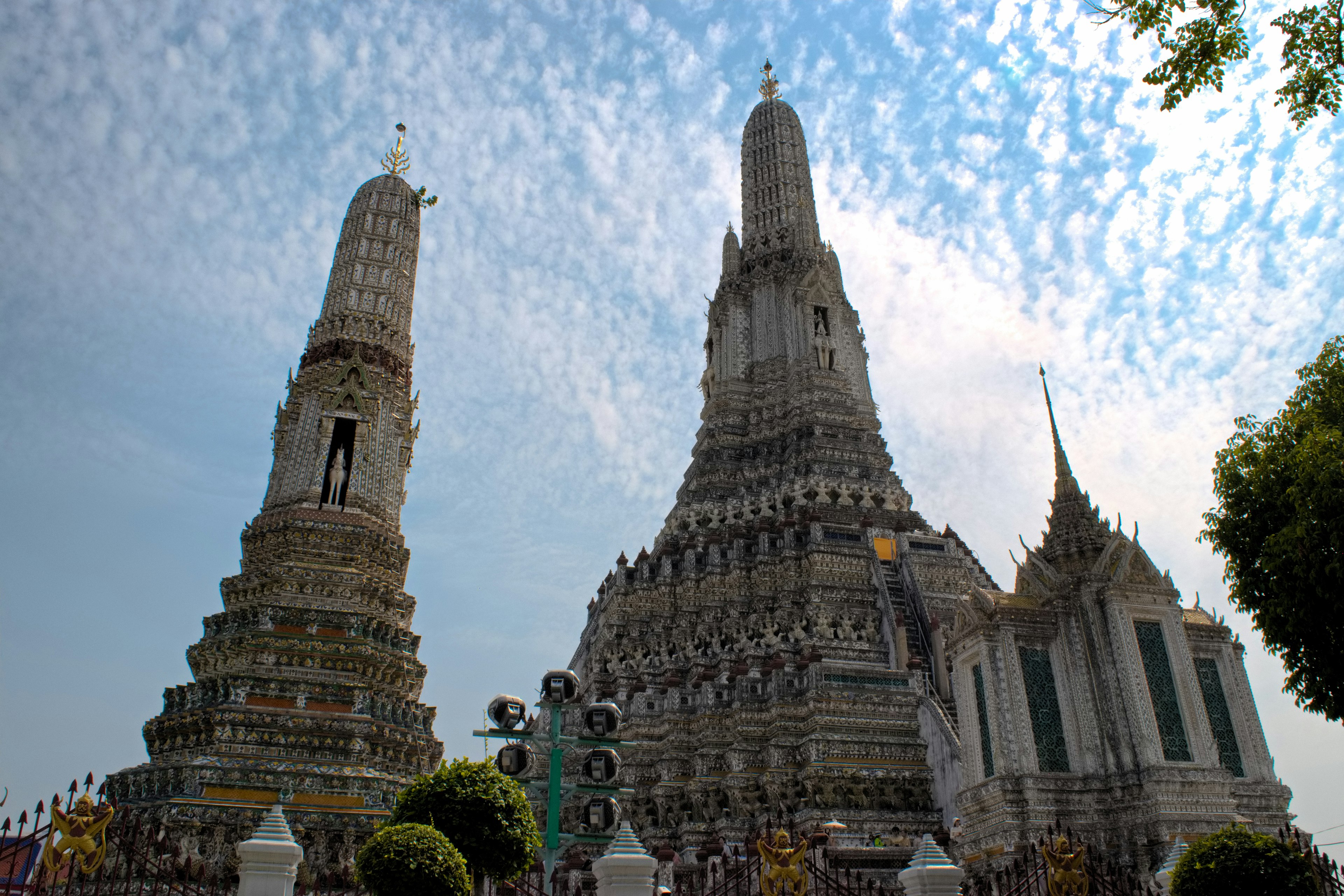 Wat Arun in Bangkok featuring stunning pagodas and a blue sky