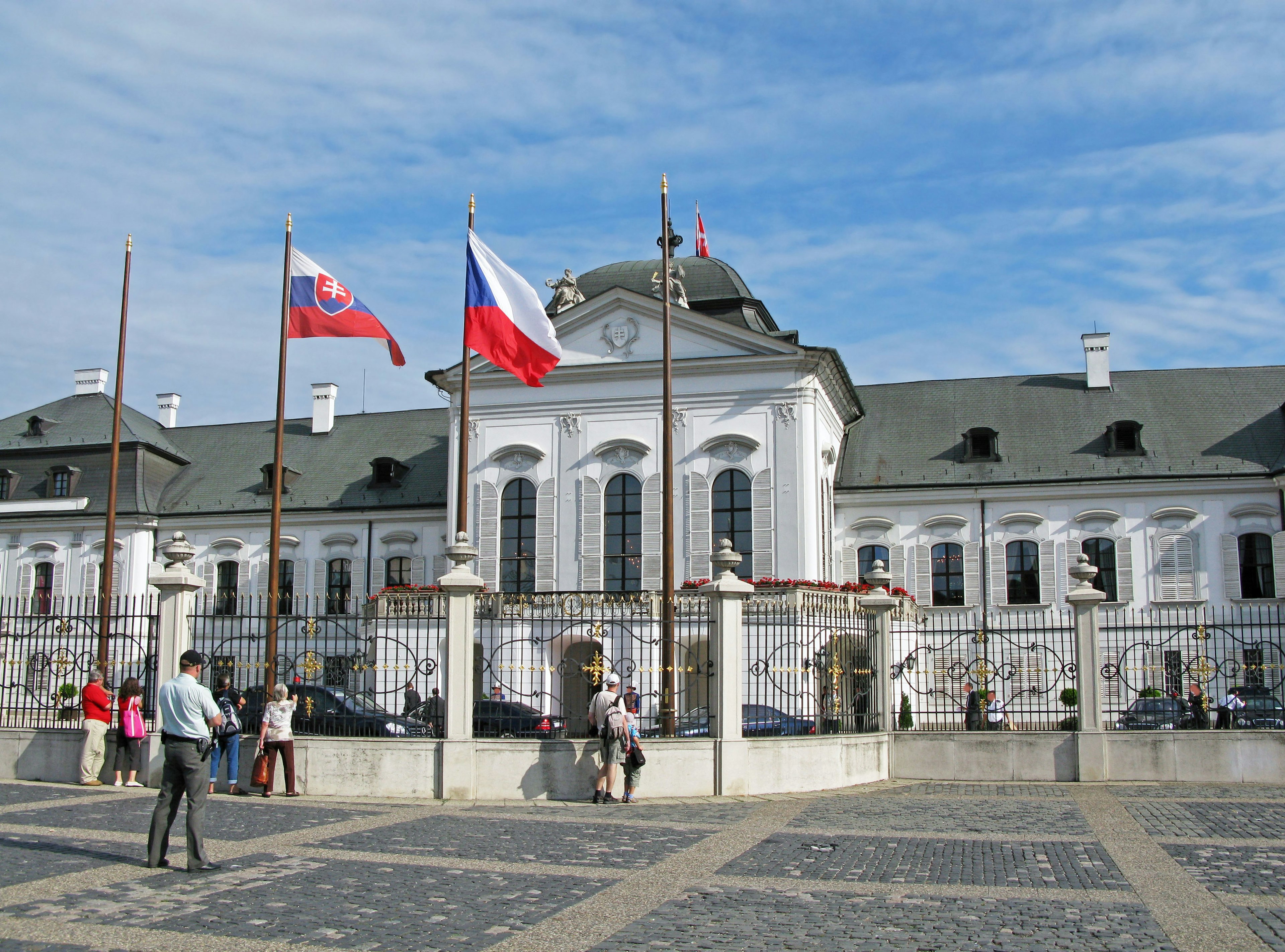 Exterior of the Slovak Presidential Palace with flags and people