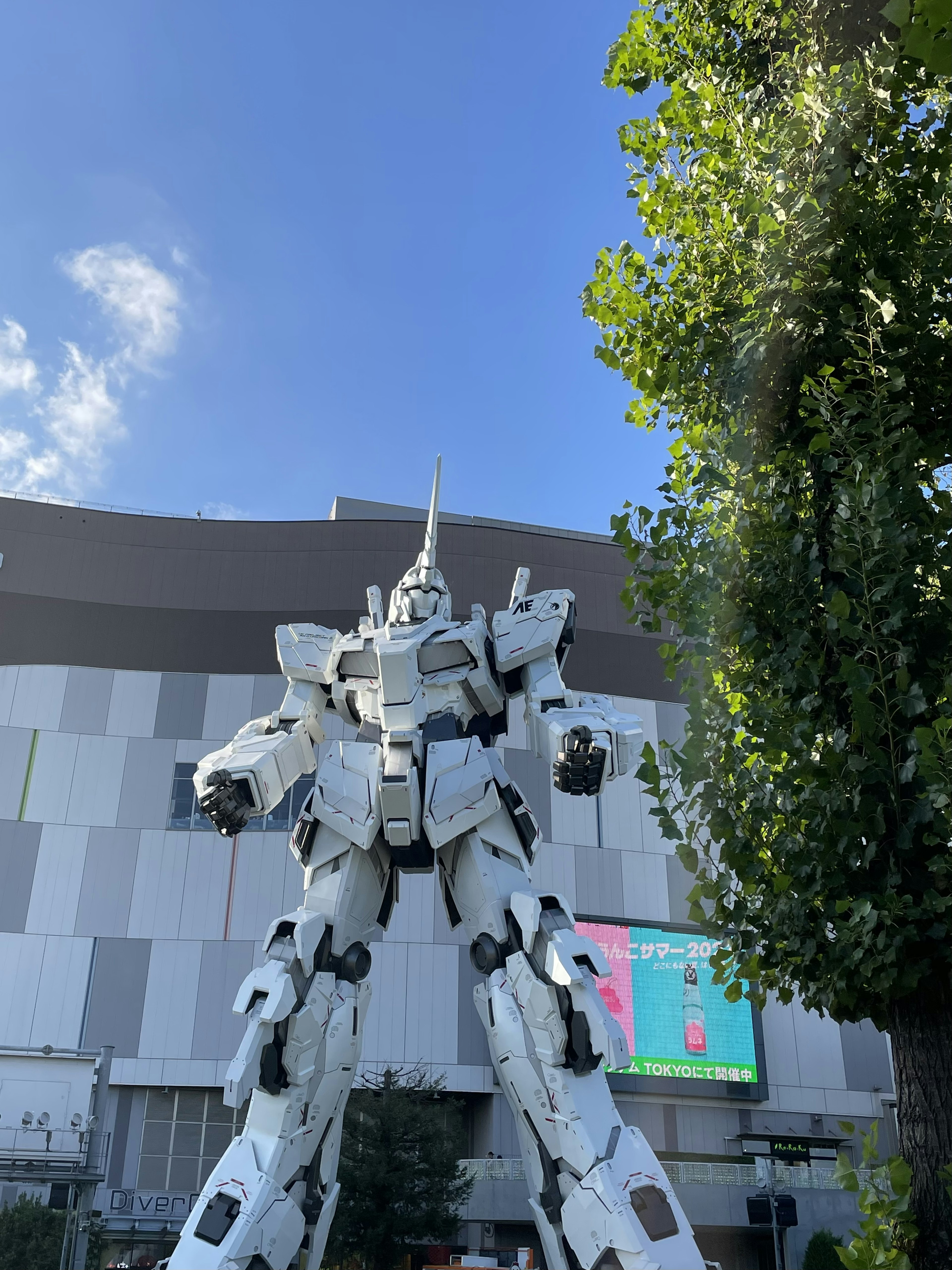 A giant robot statue stands under a blue sky