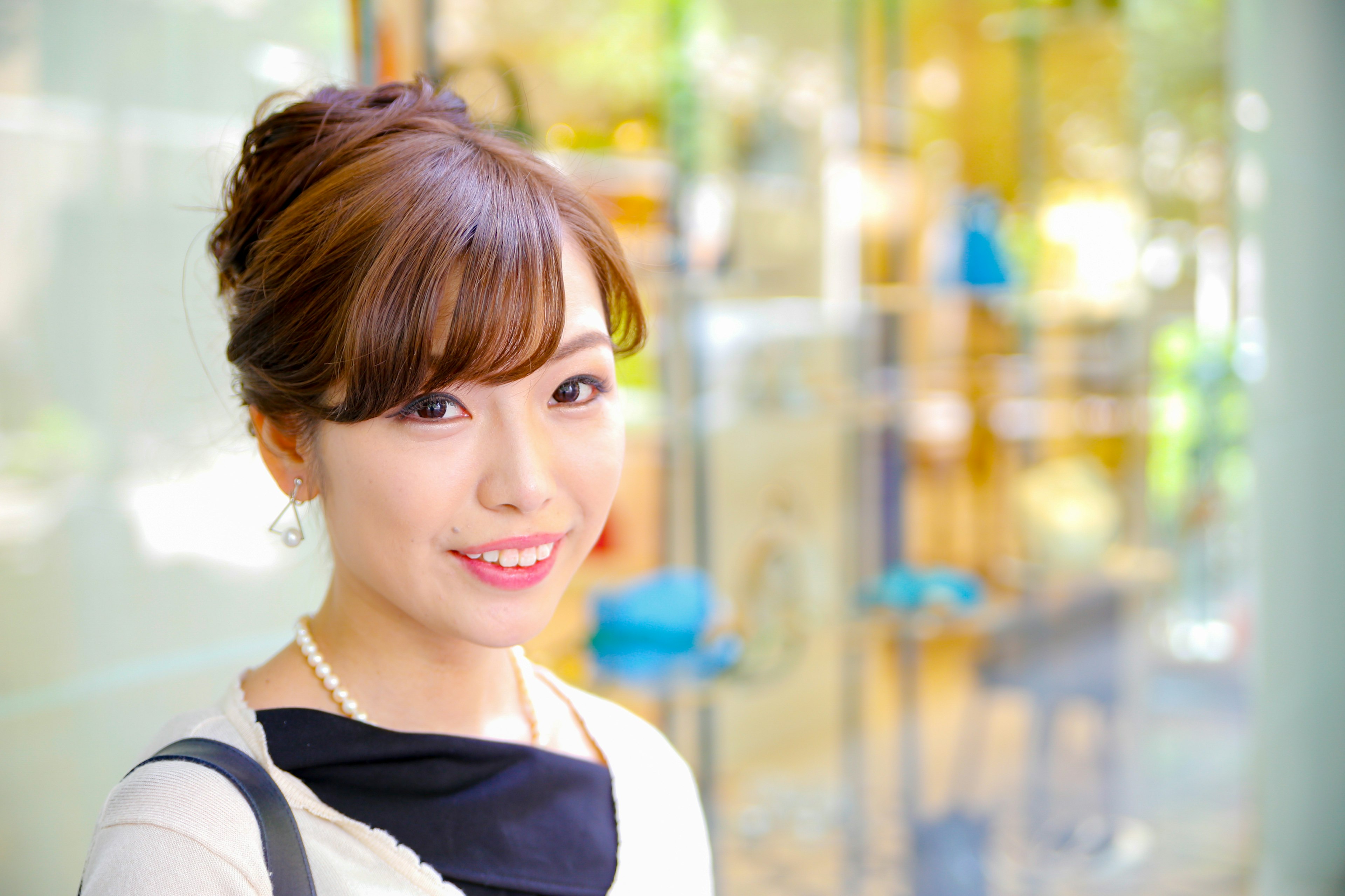 Portrait of a smiling woman standing in front of a bright background