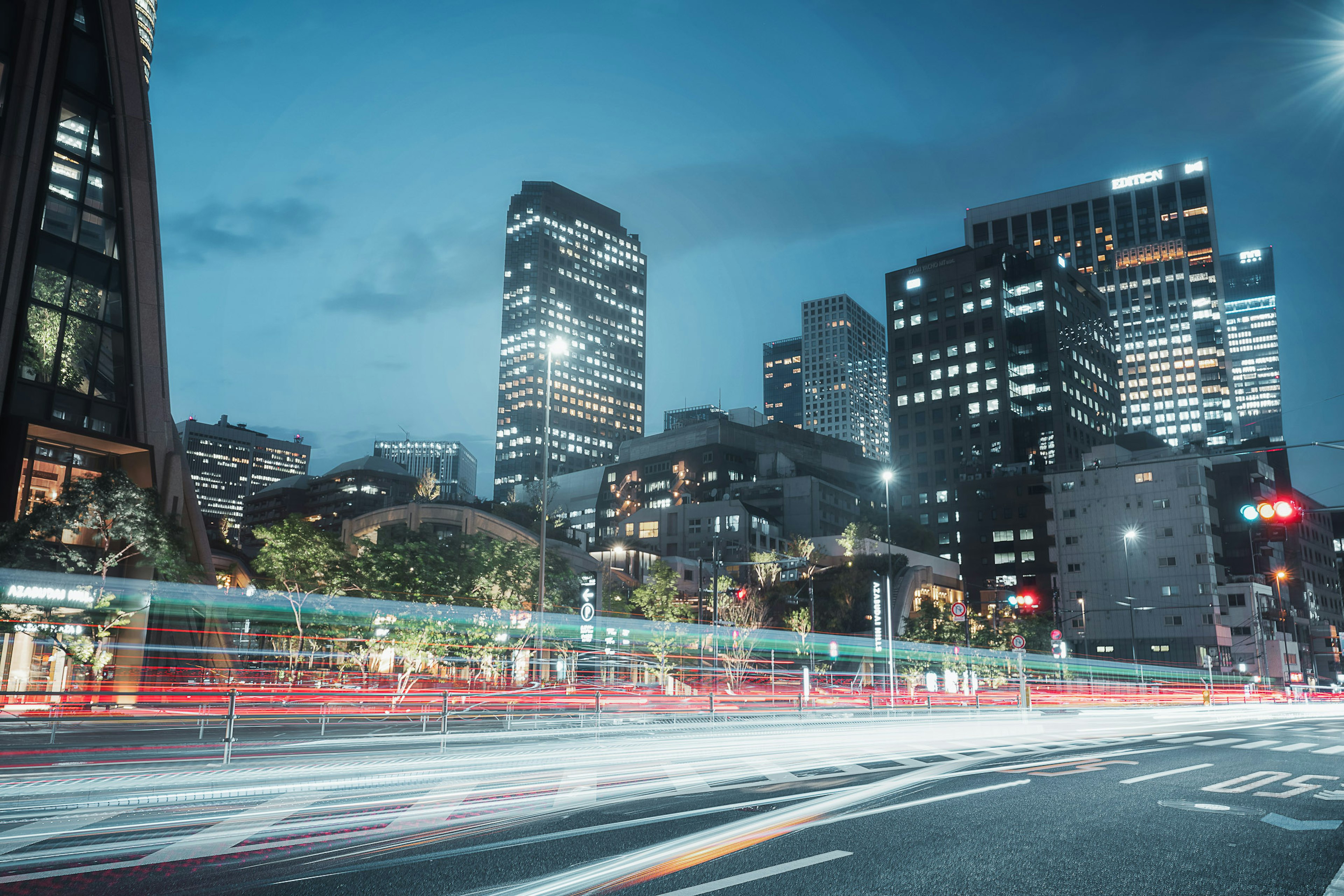 City skyline at night with streaks of car lights