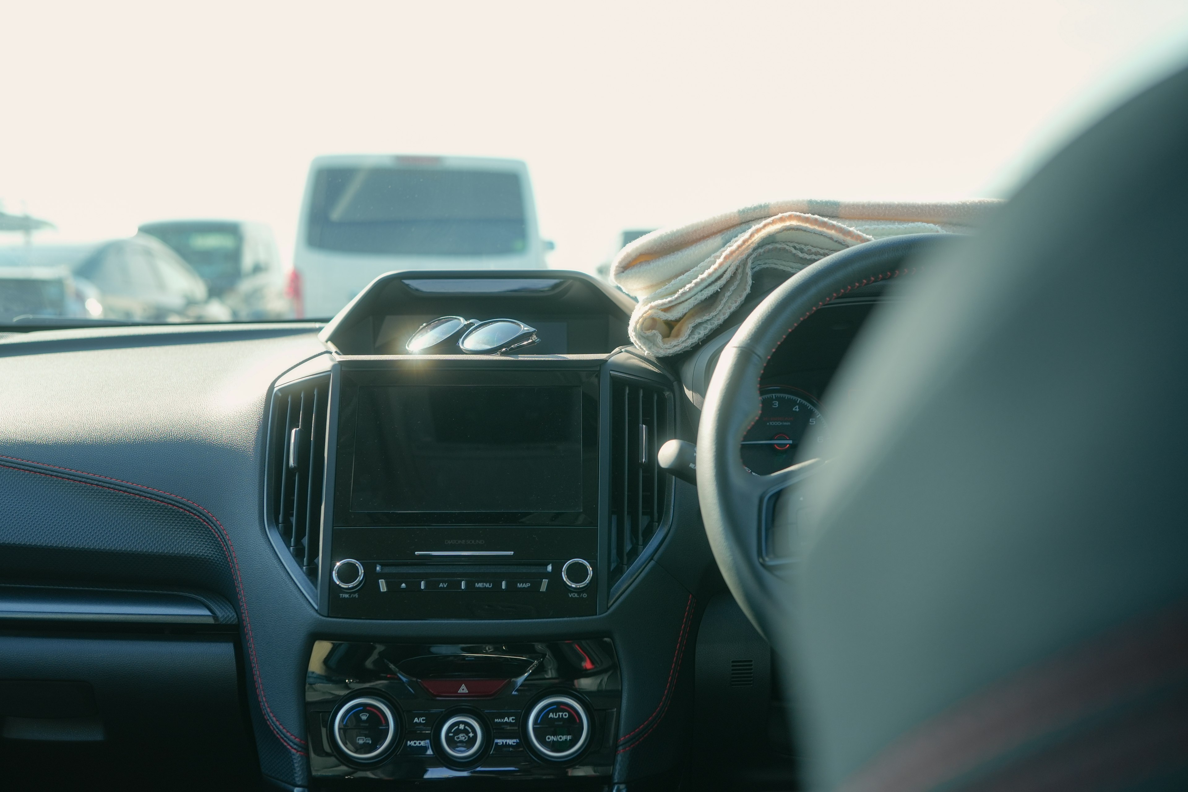 Interior view of a car dashboard and steering wheel