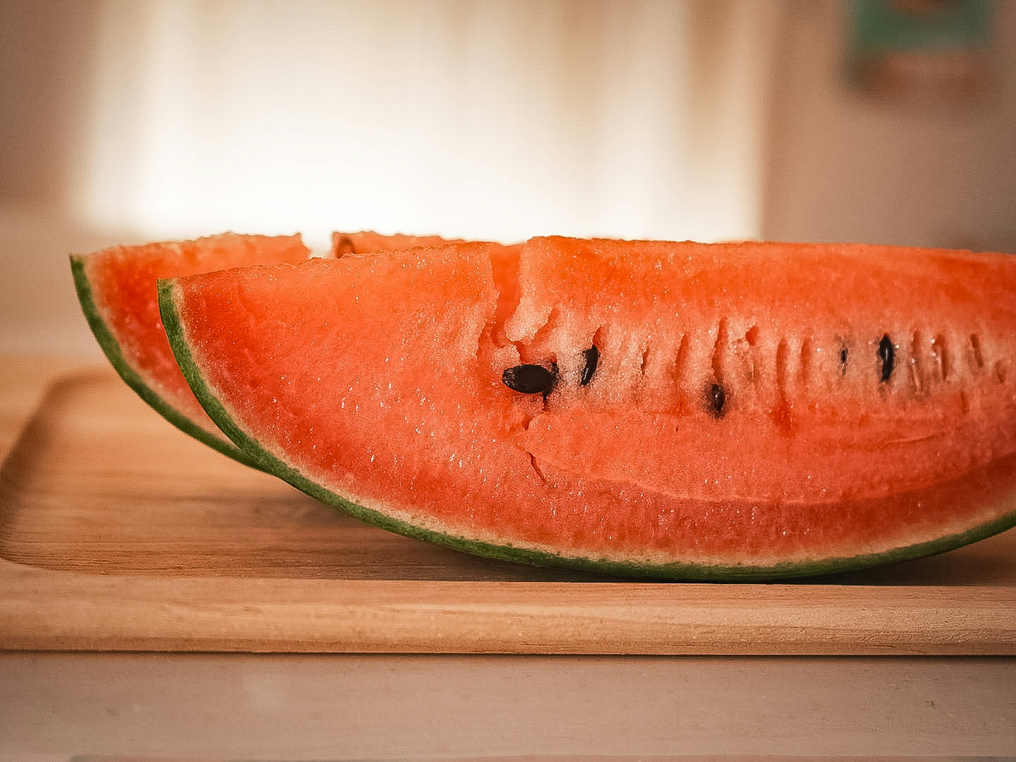 Sliced watermelon placed on a wooden board